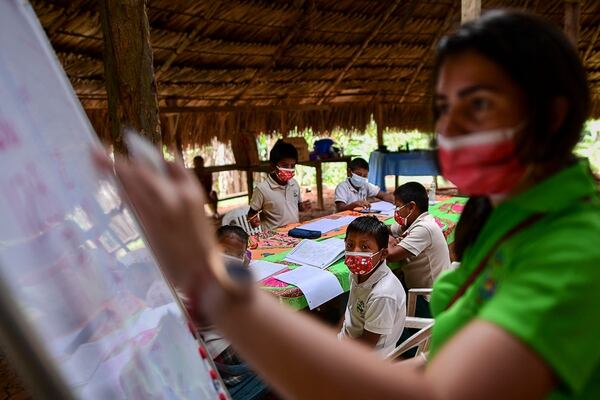 La maestra panameña Graciela Bouche da clases a los niños indígenas en la comunidad de Ella Puru, provincia de Colón, Panamá, el 9 de marzo del 2021. Foto: AFP