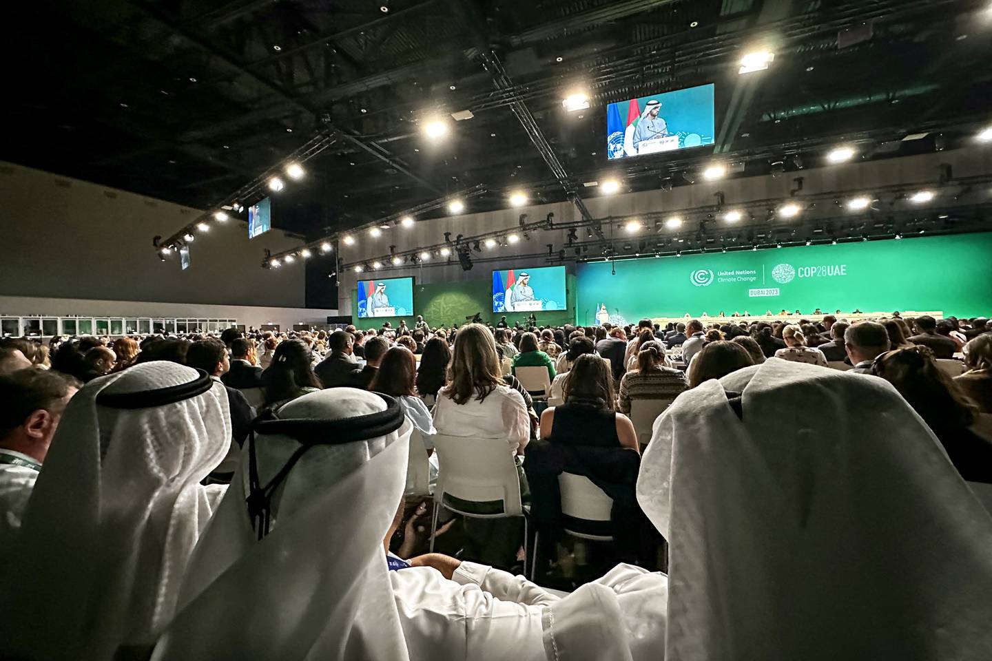 Participants attend a COP28 a plenary session at the United Nations climate summit in Dubai on December 13, 2023. Nations adopted the first ever UN climate deal that calls for the world to transition away from fossil fuels. "We have the basis to make transformational change happen," COP28 president Sultan Al Jaber said at the UN climate summit in Dubai before the deal was adopted by consensus, prompting delegates to rise and applaud. (Photo by Giuseppe CACACE / AFP)