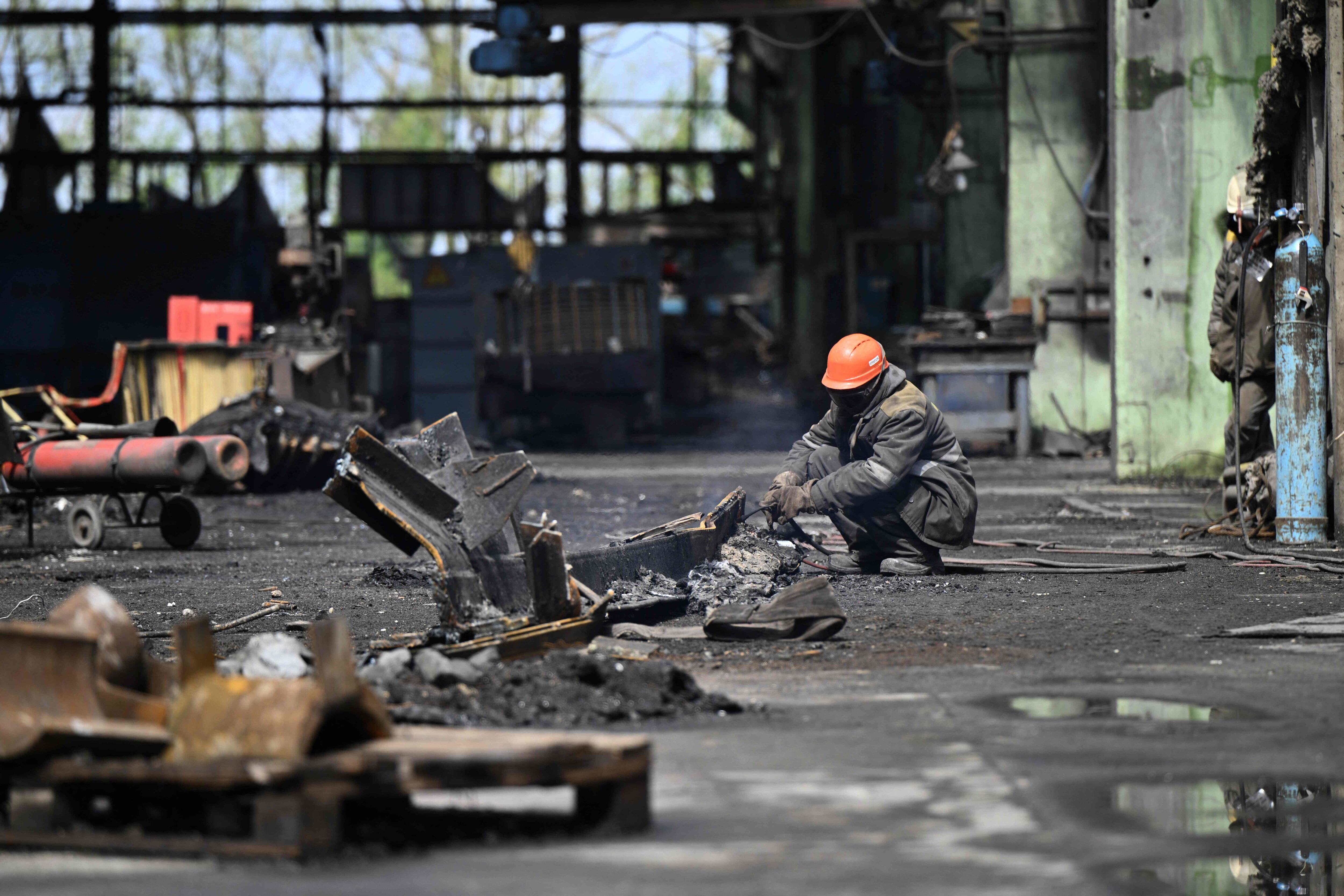 Un trabajador recoge los escombros de la central energética rusa que fue atacada por Ucrania la noche de este viernes. FOTO: AFP