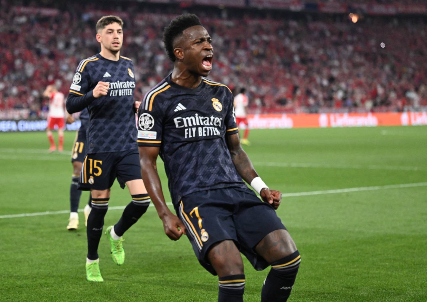 Real Madrid's Brazilian forward #07 Vinicius Junior celebrates scoring a penalty during the UEFA Champions League semi-final first leg football match between FC Bayern Munich and Real Madrid CF on April 30, 2024 in Munich, southern Germany. (Photo by Kirill KUDRYAVTSEV / AFP)