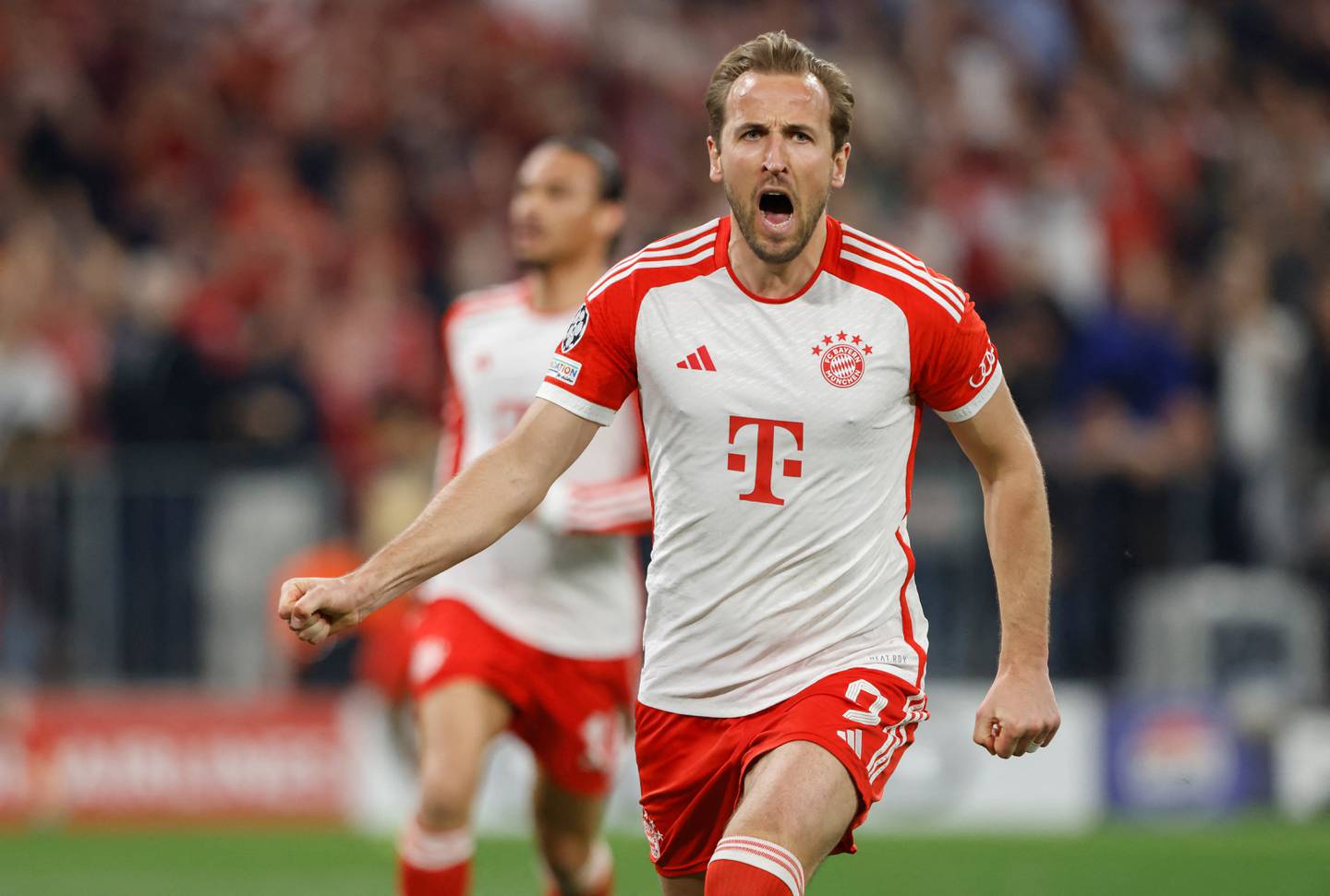 Bayern Munich's English forward #09 Harry Kane celebrates scoring the 2-1 goal from the penalty spot with his team-mates during the UEFA Champions League semi-final first leg football match between FC Bayern Munich and Real Madrid CF on April 30, 2024 in Munich, southern Germany. (Photo by Michaela STACHE / AFP)