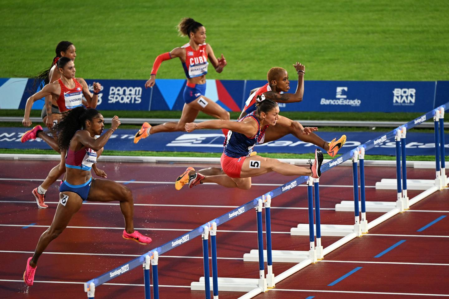 Costa Rica's Andrea Carolina Vargas Mena crosses the line to win the women's 100m hurdles final of the Pan American Games Santiago 2023 at the National Stadium in Santiago, on November 1st, 2023. (Photo by MAURO PIMENTEL / AFP)