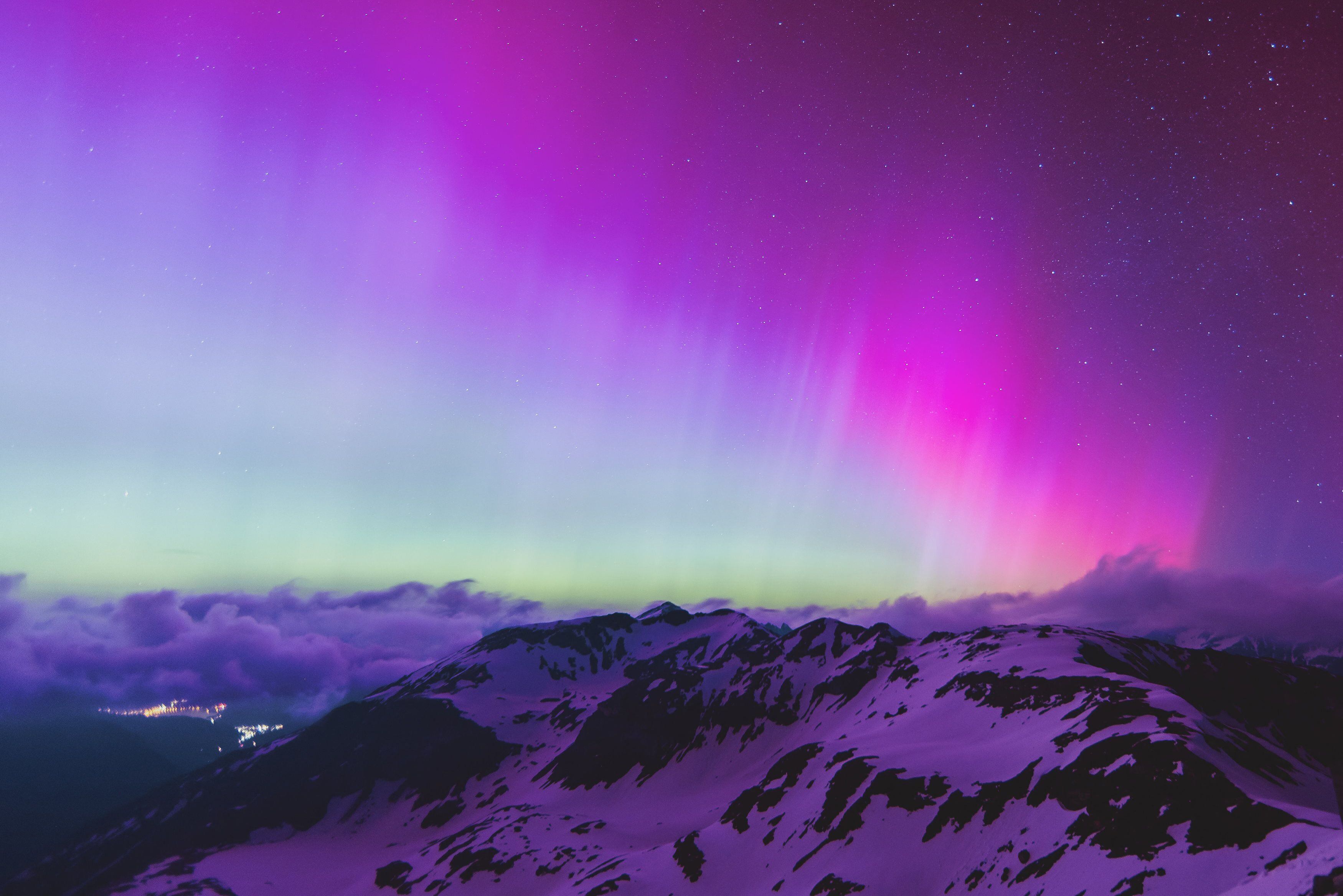 Una aurora boreal es un fenómeno natural en el que se observan luces brillantes y coloridas en el cielo nocturno, principalmente en regiones polares. Estas luces son causadas por la interacción entre partículas cargadas del viento solar y los gases atmosféricos de la Tierra. Cuando estas partículas chocan con la atmósfera terrestre, producen un resplandor luminoso que puede ser de diferentes colores, como verde, azul, rosa o púrpura. Foto: AFP