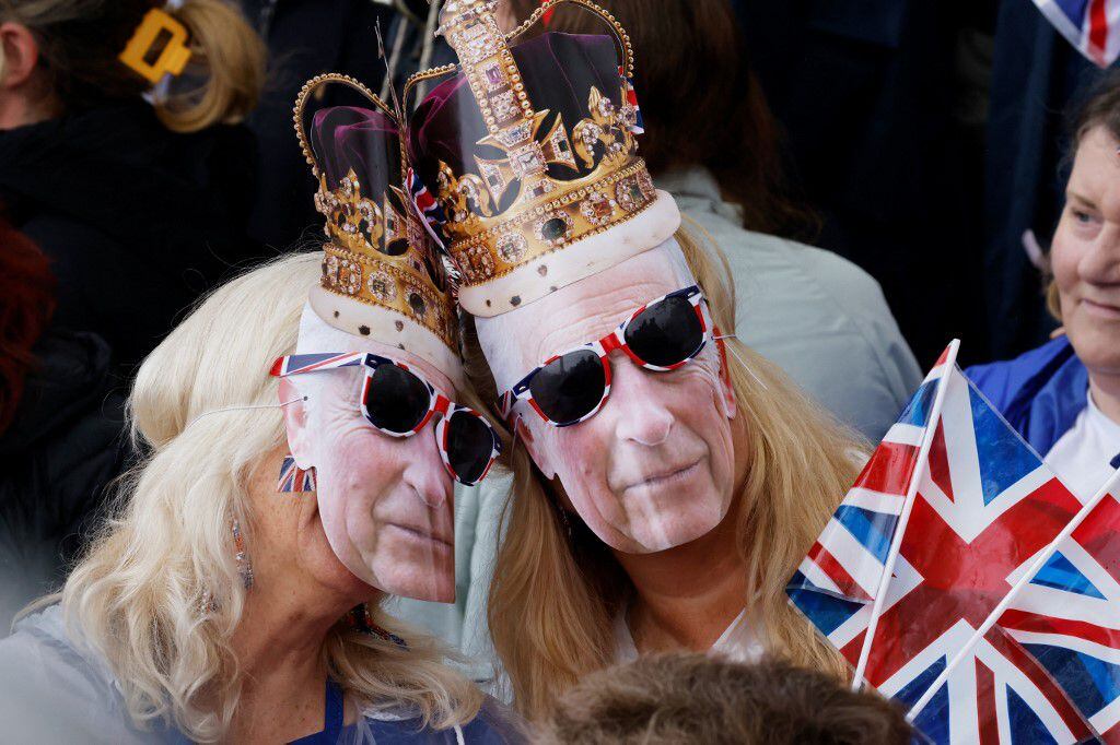 Las curiosas máscaras del rostro de Carlos III también se veían entre la multitud. 