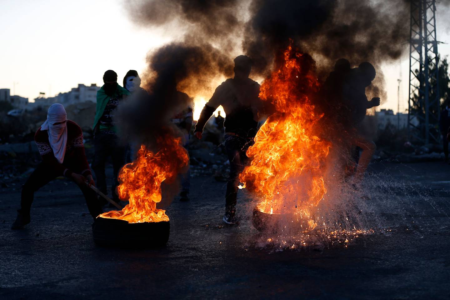 El sábado, manifestantes palestinos movían neumáticos en llamas durante los enfrentamientos con las fuerzas israelíes, cerca de un puesto de control israelí en la ciudad cisjordana de Ramala.