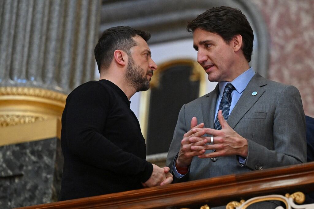 Ukraine's President Volodymyr Zelensky (L) and Canada's Prime Minister Justin Trudeau (R) speak on the stairs on their way to a plenary meeting at a summit held at Lancaster House in central London on March 2, 2025. European leaders descend upon London today for talks to "drive forward" action on Ukraine, according to the office of UK Prime Minister Keir Starmer. The summit caps off a week of intense diplomacy for host Starmer, who met with President Donald Trump on Thursday in an effort to draw together the European and US approaches to the Ukraine conflict. (Photo by JUSTIN TALLIS / POOL / AFP)