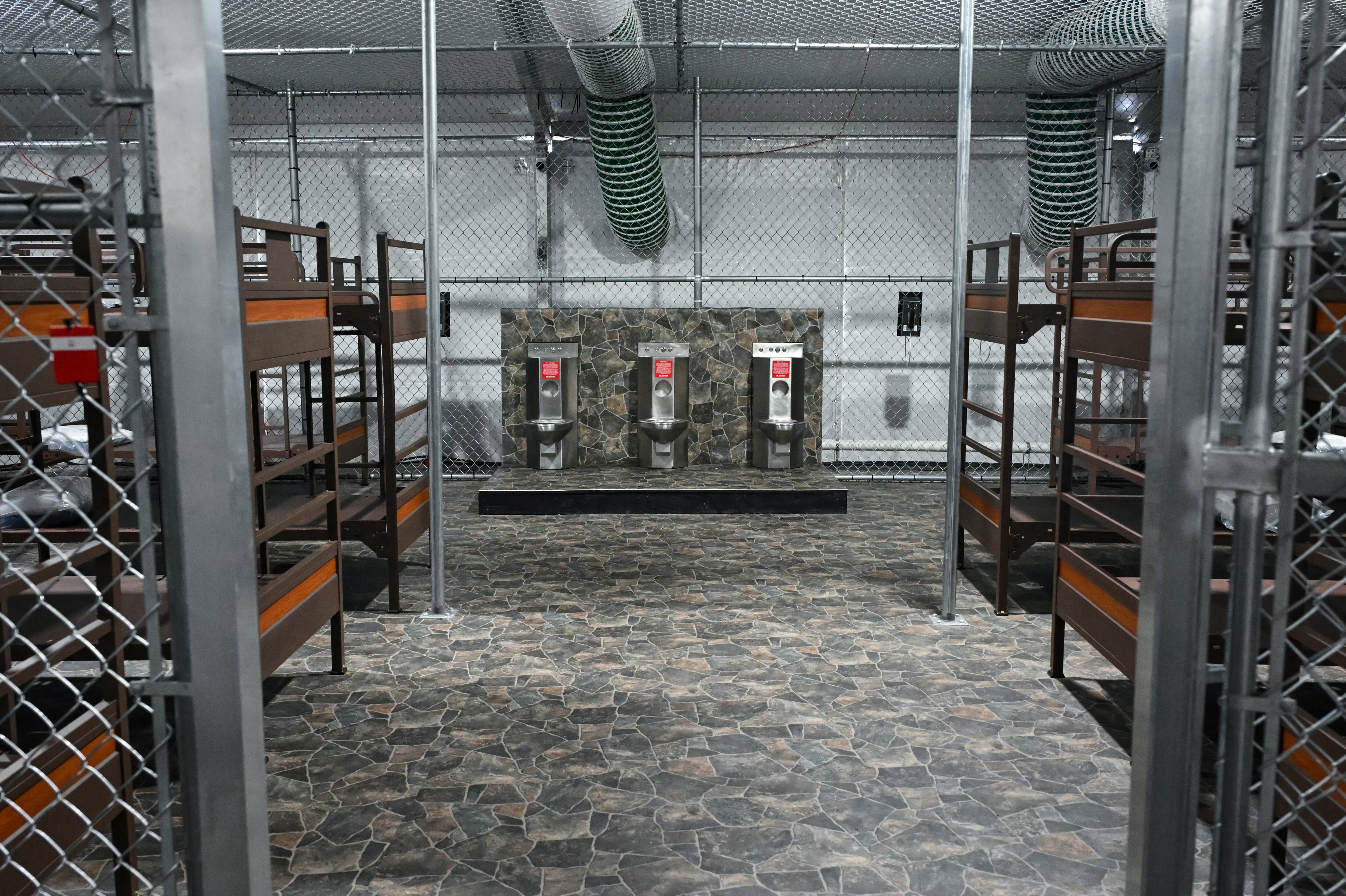 US President President Donald Trump tours a migrant detention center, dubbed "Alligator Alcatraz," located at the site of the Dade-Collier Training and Transition Airport in Ochopee, Florida on July 1, 2025. President Trump is visiting a migrant detention center in a reptile-infested Florida swamp dubbed "Alligator Alcatraz." Trump will attend the opening of the 5,000-bed facility -- located at an abandoned airfield in the Everglades wetlands -- part of his expansion of deportations of undocumented migrants, his spokeswoman said. (Photo by ANDREW CABALLERO-REYNOLDS / AFP)