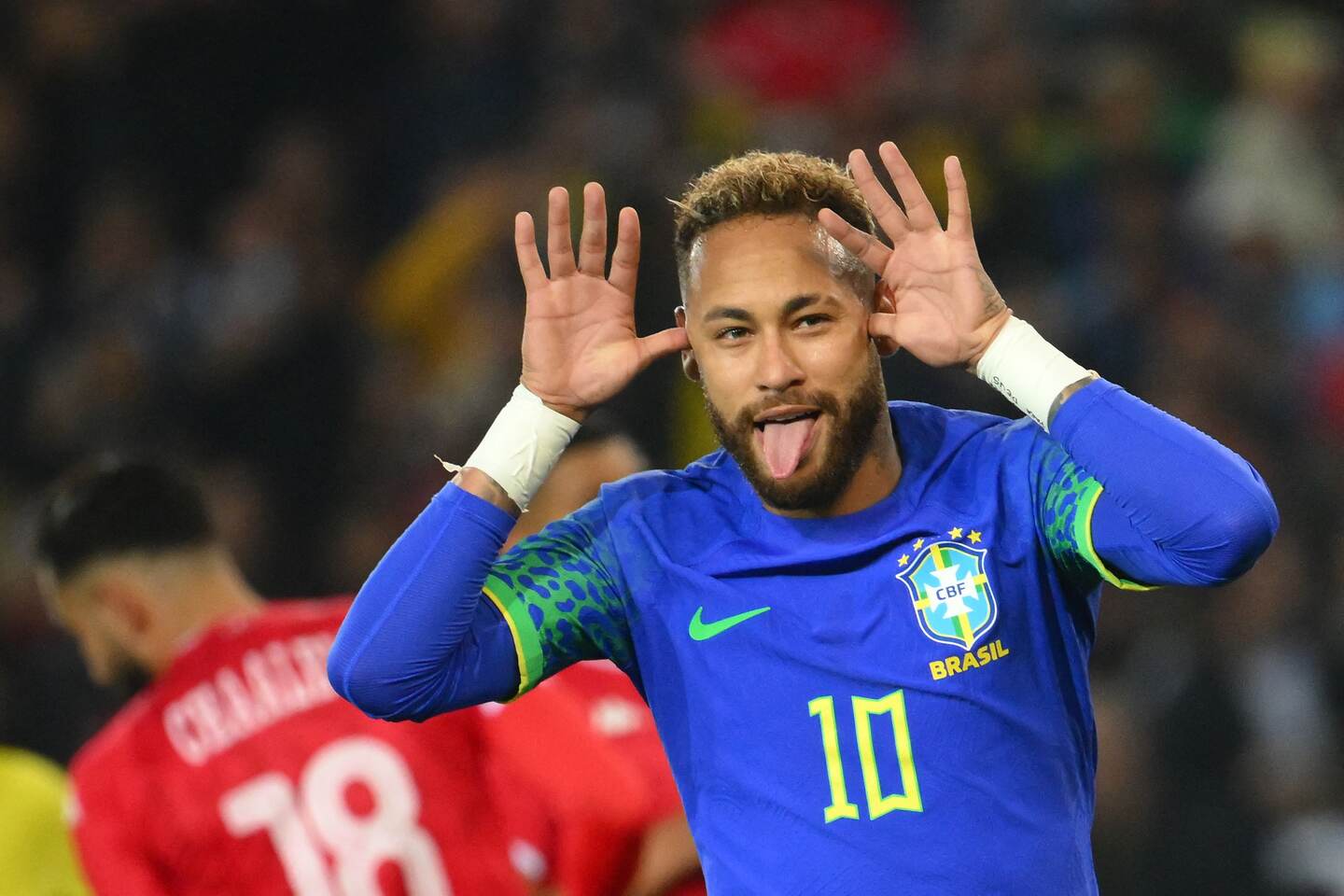 (FILES) In this file photo taken on September 27, 2022, Brazil's forward Neymar celebrates scoring his team's third goal during the friendly football match between Brazil and Tunisia at the Parc des Princes in Paris. - Brazilian President Jair Bolsonaro got a celebrity endorsement on September 29 for his re-election bid from football superstar Neymar, who posted a video on TikTok of himself dancing and grinning to a pro-Bolsonaro campaign song. (Photo by Anne-Christine POUJOULAT / AFP)