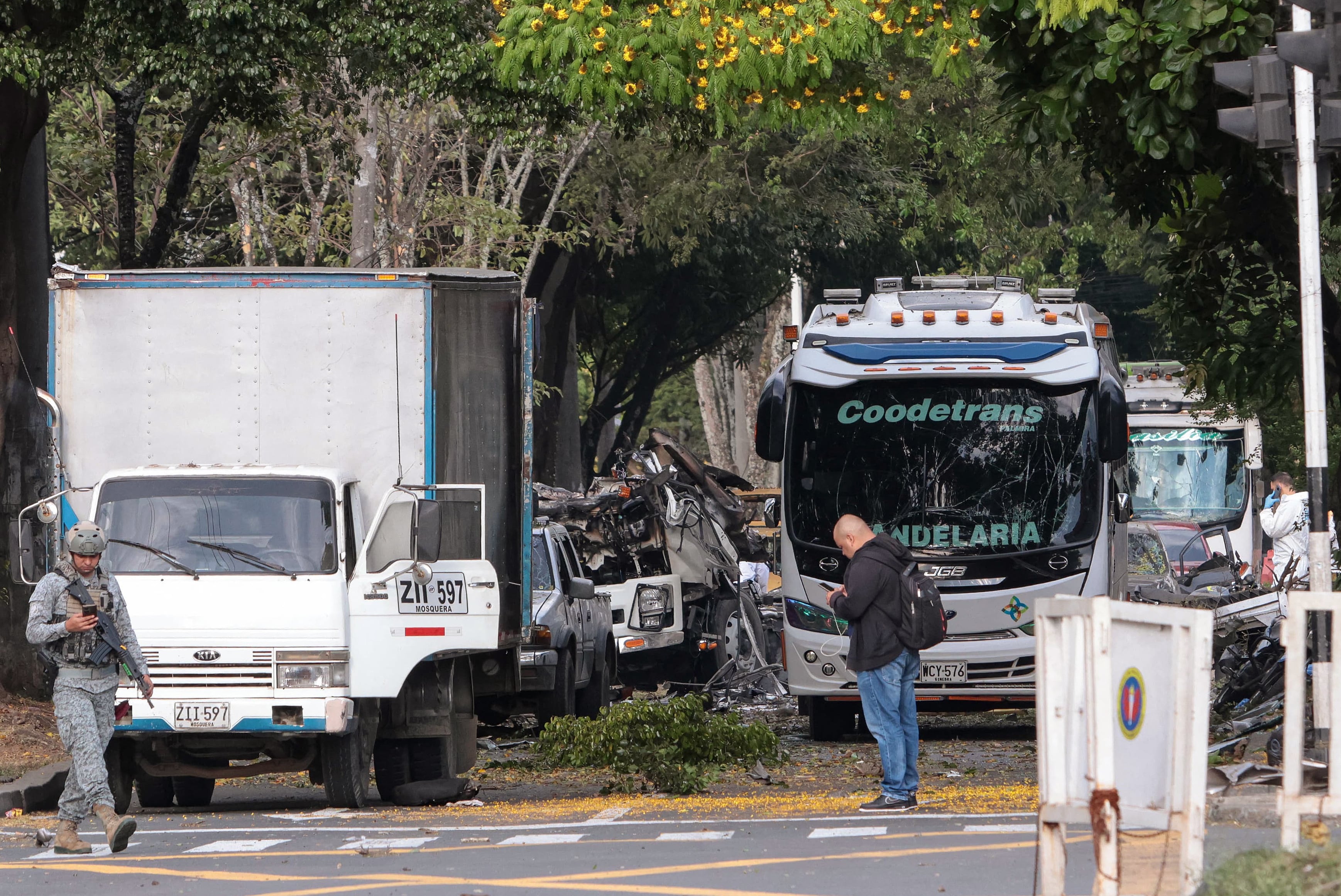 Members of Colombian security forces inspect the area of a bomb explosion in cali, Colombia on August 21 2025. Five people were killed and dozens were injured when a vehicle bomb targeted a military base on a busy street in the Colombian city of Cali on August 21, 2025, local authorities said. (Photo by Iusef Samir Rojas / AFP)
