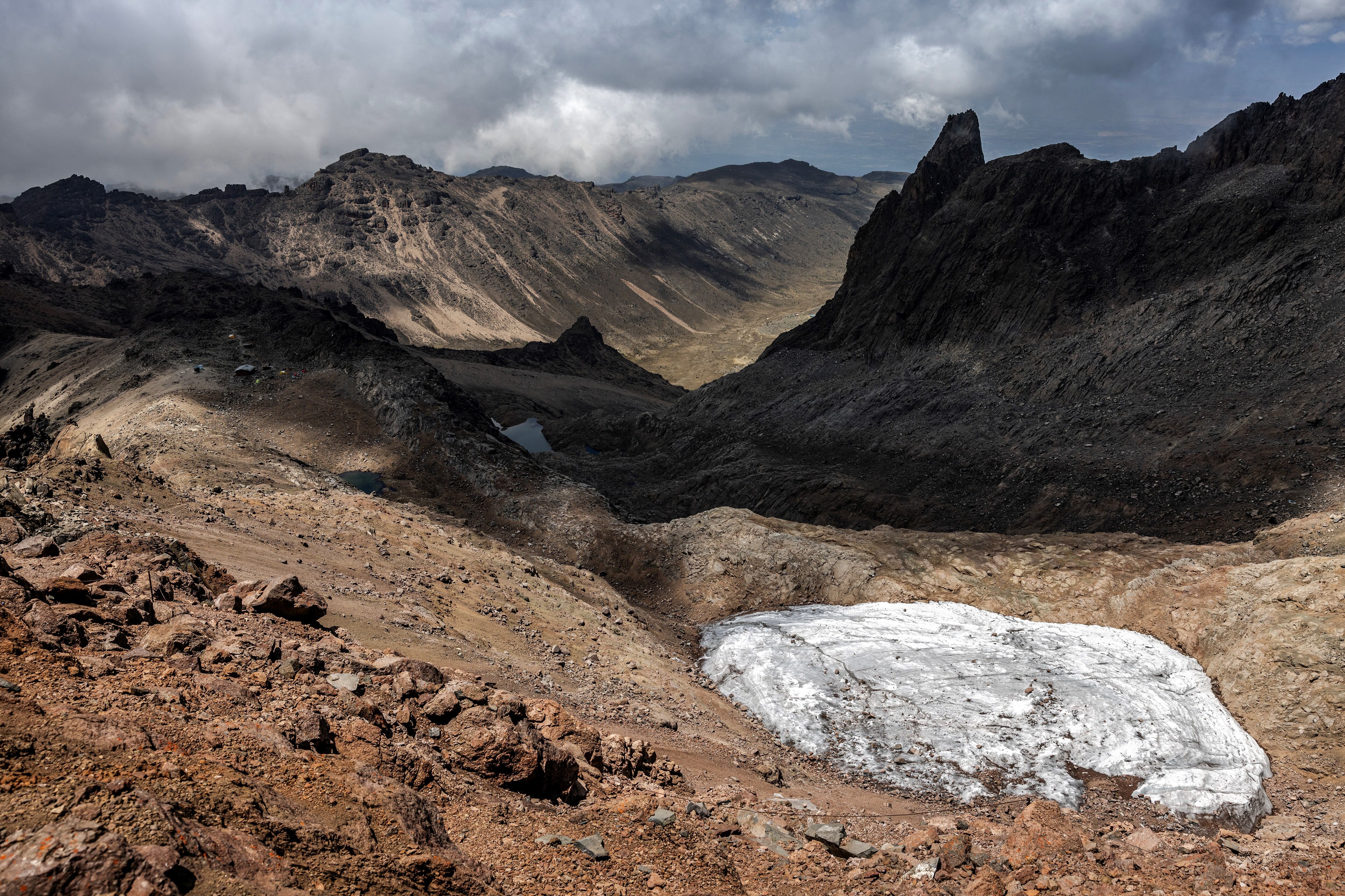 A general view of the melting Lewis Glacier in Mount Kenya National Park on March 7, 2025. Mount Kenya, Africa's second-highest peak, is home to rapidly shrinking glaciers that are vital for nearby ecosystems and communities. Lewis Glacier, the most studied, has lost over 90% of its mass since 1934, according to the World Glacier Monitoring Service (WGMS). This dramatic loss is driven by rising temperatures and declining rainfall, both tied by experts to global climate change. The glaciers' disappearance threatens water sources for millions, impacting farming, hydroelectric power, and biodiversity. The loss also endangers local economies that depend on agriculture and ecotourism tied to the mountain's unique ecosystem. (Photo by Luis TATO / AFP)