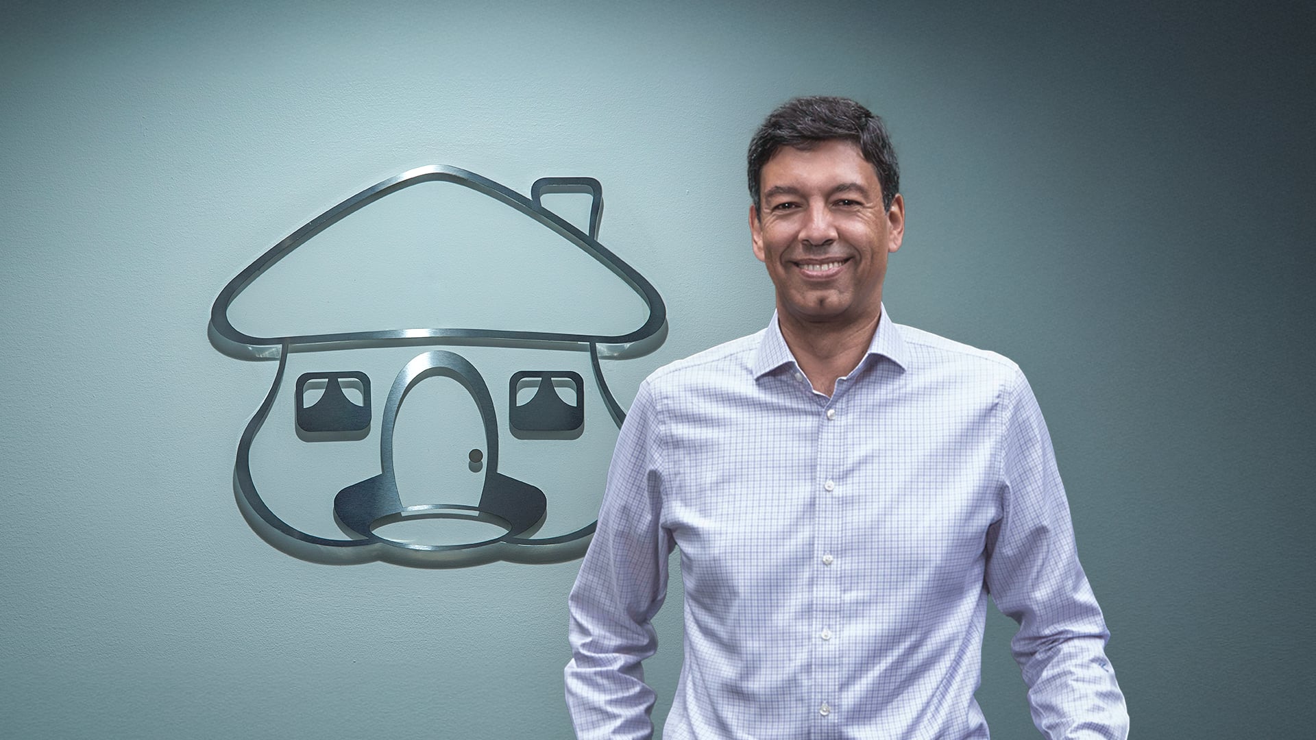 Javier Suárez, presidente de Davivienda, frente a un logo metálico de Davivienda.