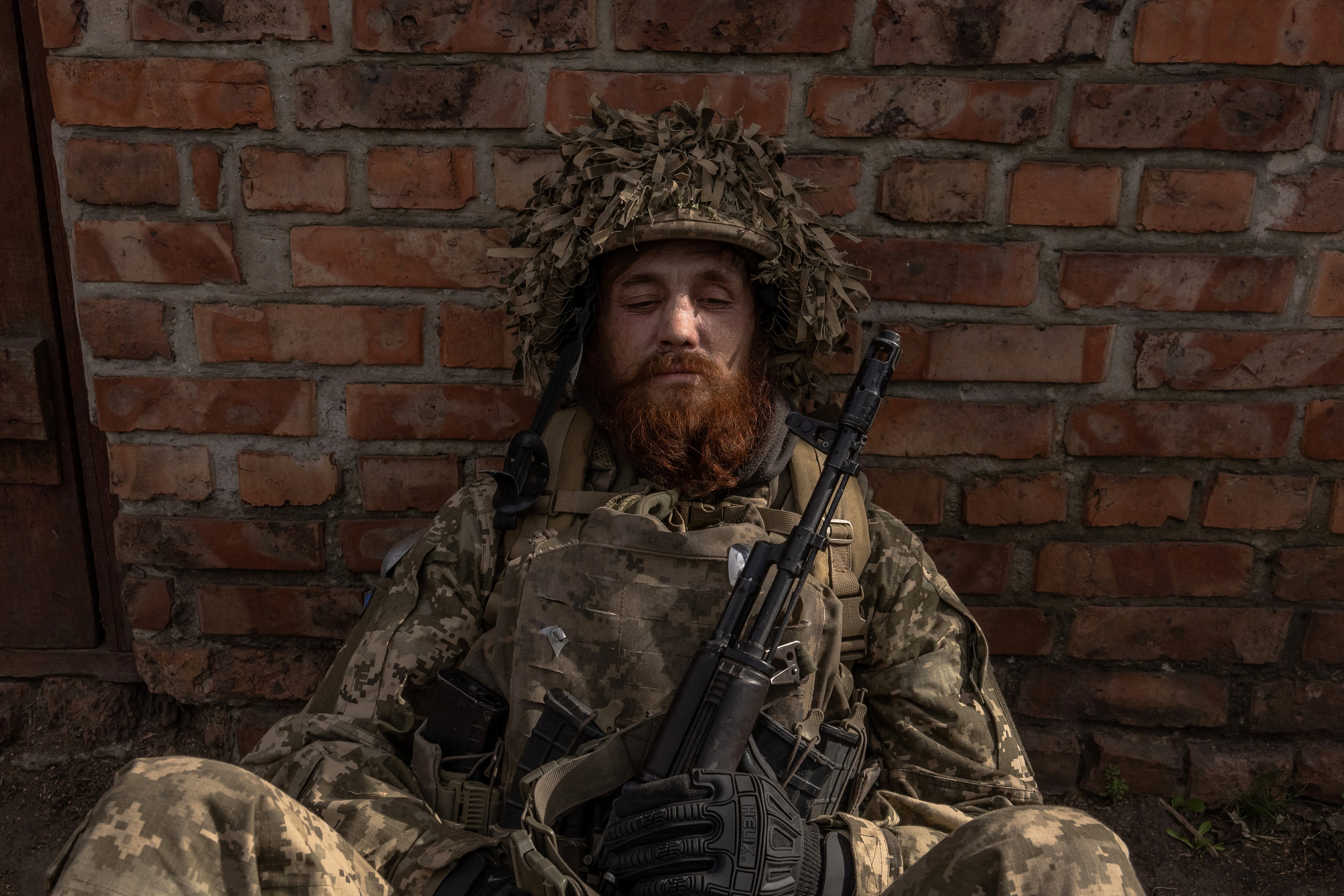 (FILES) A Ukrainian infantry soldier of the 23rd Mechanized Brigade waits to head toward the frontline in the Avdiivka direction, in the Donetsk region, on April 3, 2024, amid the Russian invasion of Ukraine. (Photo by Roman PILIPEY / AFP)