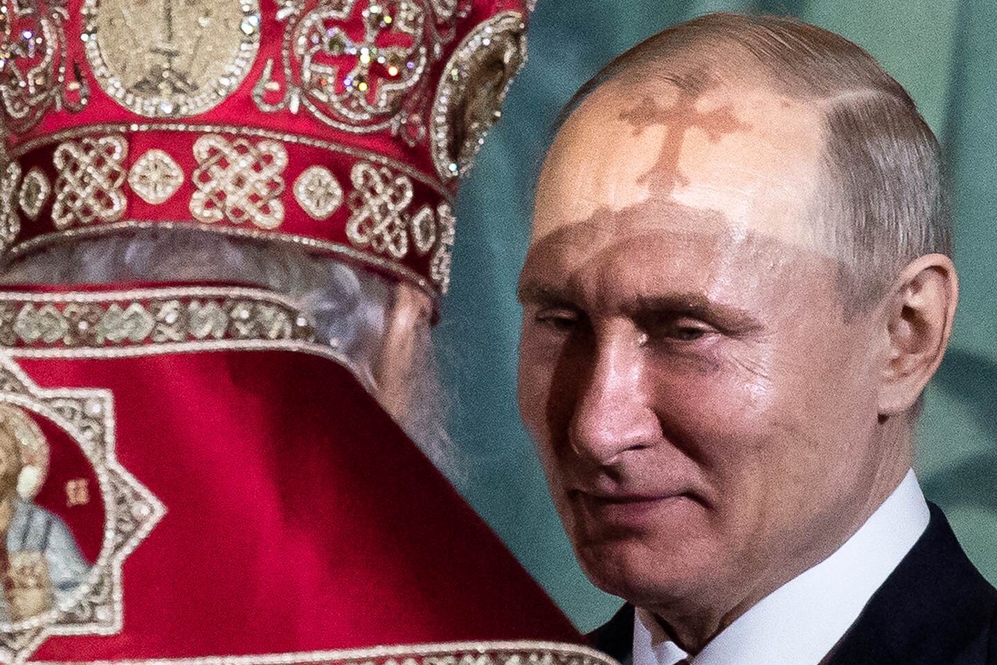 FILE - In this Sunday, April 28, 2019 file photo, President Vladimir Putin, right, talks with Russian Orthodox Patriarch Kirill during the Easter service in the Christ the Savior Cathedral in Moscow, Russia. Russian President Vladimir Putin on Monday submitted a slew of new proposed amendments to the country's Constitution that include a mention of God and describe marriage as a heterosexual union. (AP Photo/Alexander Zemlianichenko, File)