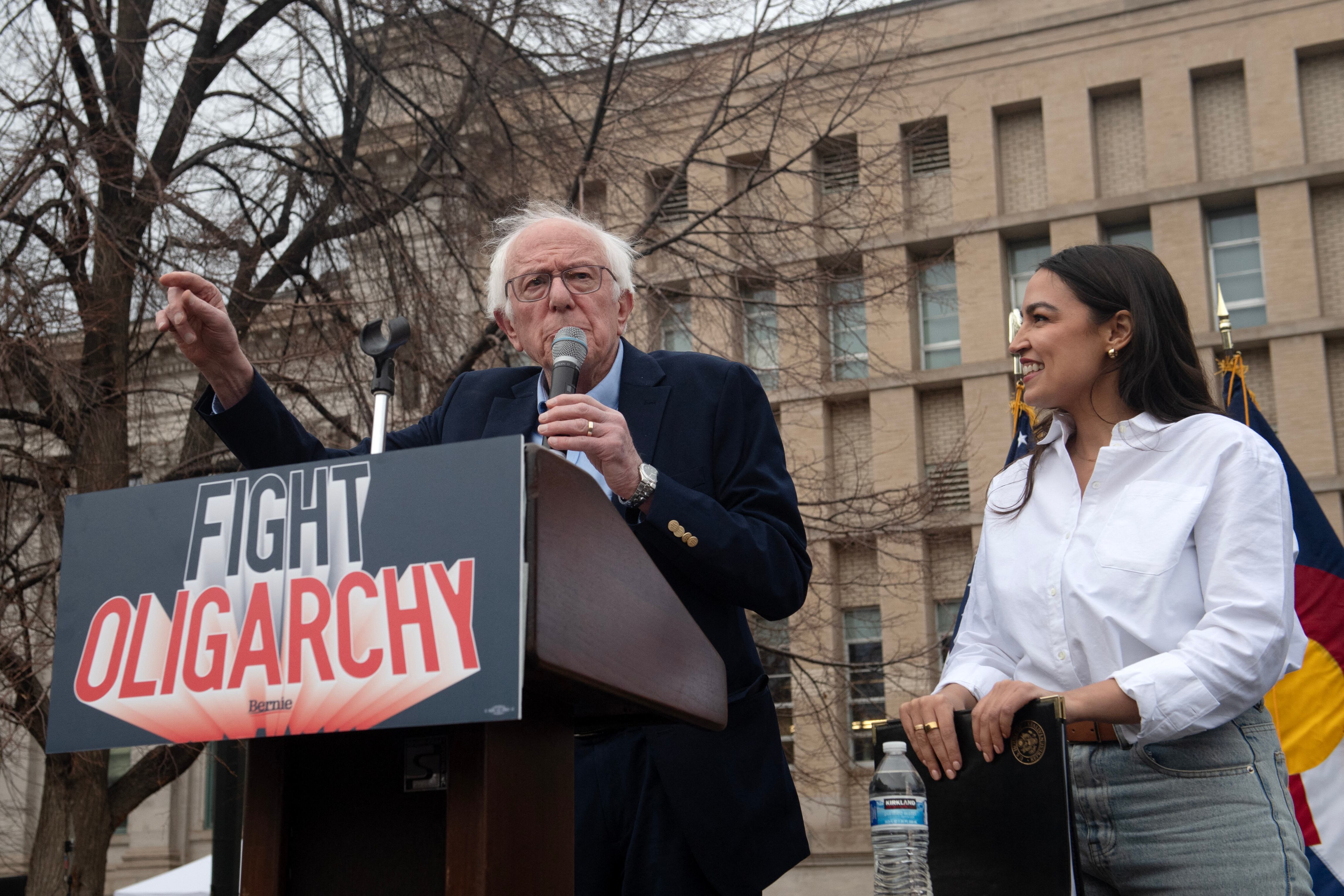 (FILES) US Senator Bernie Sanders, Independent from Vermont, and US Representative Alexandria Ocasio Cortez, Democrat of New York, speak to supporters during the "Fighting Oligarchy: Where We Go From Here" rally at Civic Center Park in Denver, Colorado on March 21, 2025. As he marks 100 days in office, much ink will be spilt on Donald Trump's divisive transformation of the US government, but Democrats are themelves under scrutiny over missteps in opposing his blitz of reforms. In AFP interviews, multiple political analysts said Democrats have become a rudderless, divided party struggling to decide what it stands for. Rare glimpses of a fightback have included victory in a Wisconsin Supreme Court race, and a hugely popular "Fighting Oligarchy" tour by progressive lawmakers Bernie Sanders and Alexandria Ocasio-Cortez. (Photo by Jason Connolly / AFP)