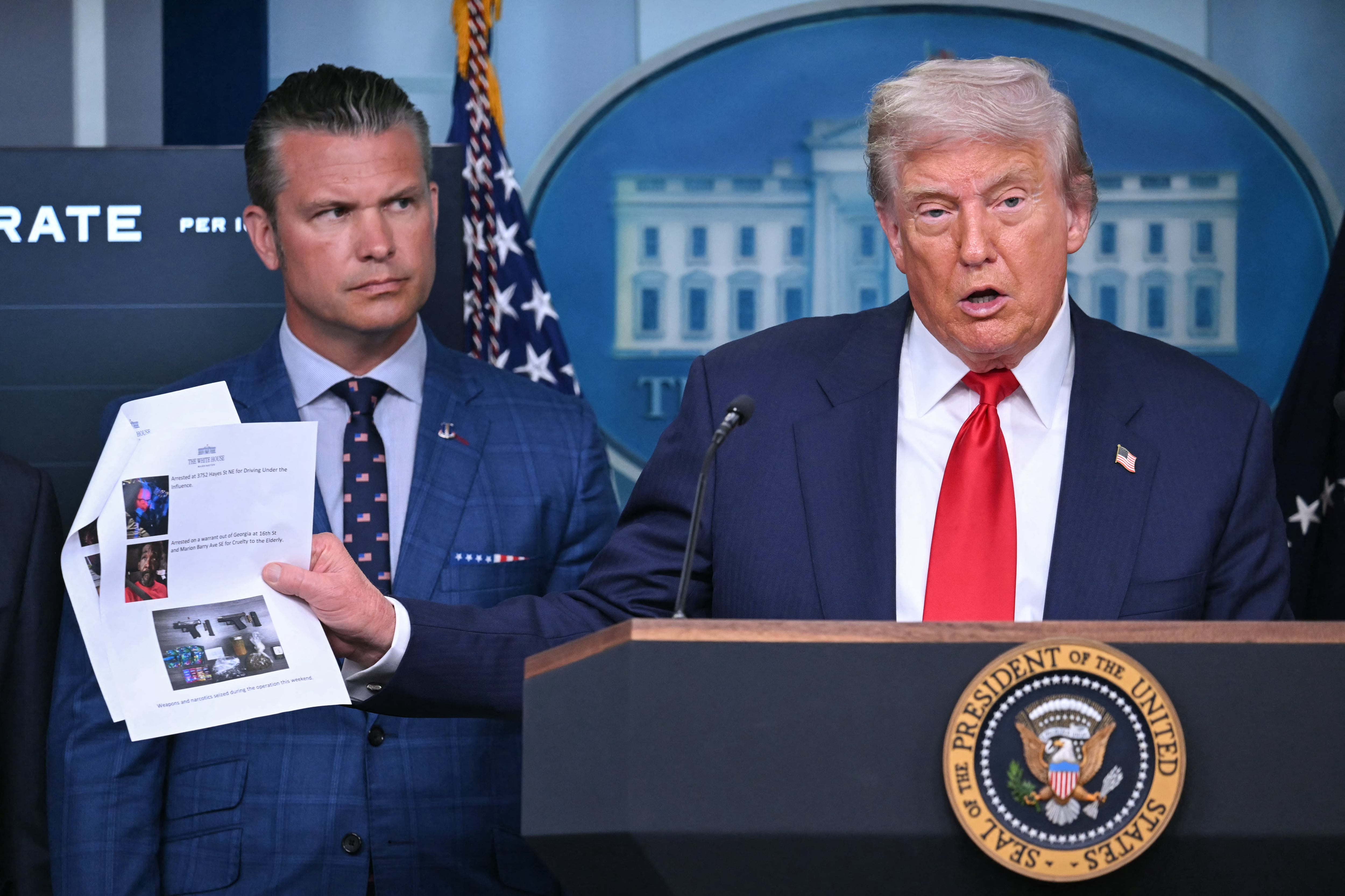 US President Donald Trump, alongside Secretary of Defense Pete Hegseth (L), speaks during a news conference to discuss crime in Washington, DC, in the Brady Press Briefing Room at the White House in Washington, DC, on August 11, 2025. President Donald Trump announced Monday that he was deploying National Guard troops and putting the Washington police force under federal control to tackle crime in the US capital. "This is Liberation Day in DC, and we're going to take our capital back," Trump said at a White House press conference. (Photo by ANDREW CABALLERO-REYNOLDS / AFP)