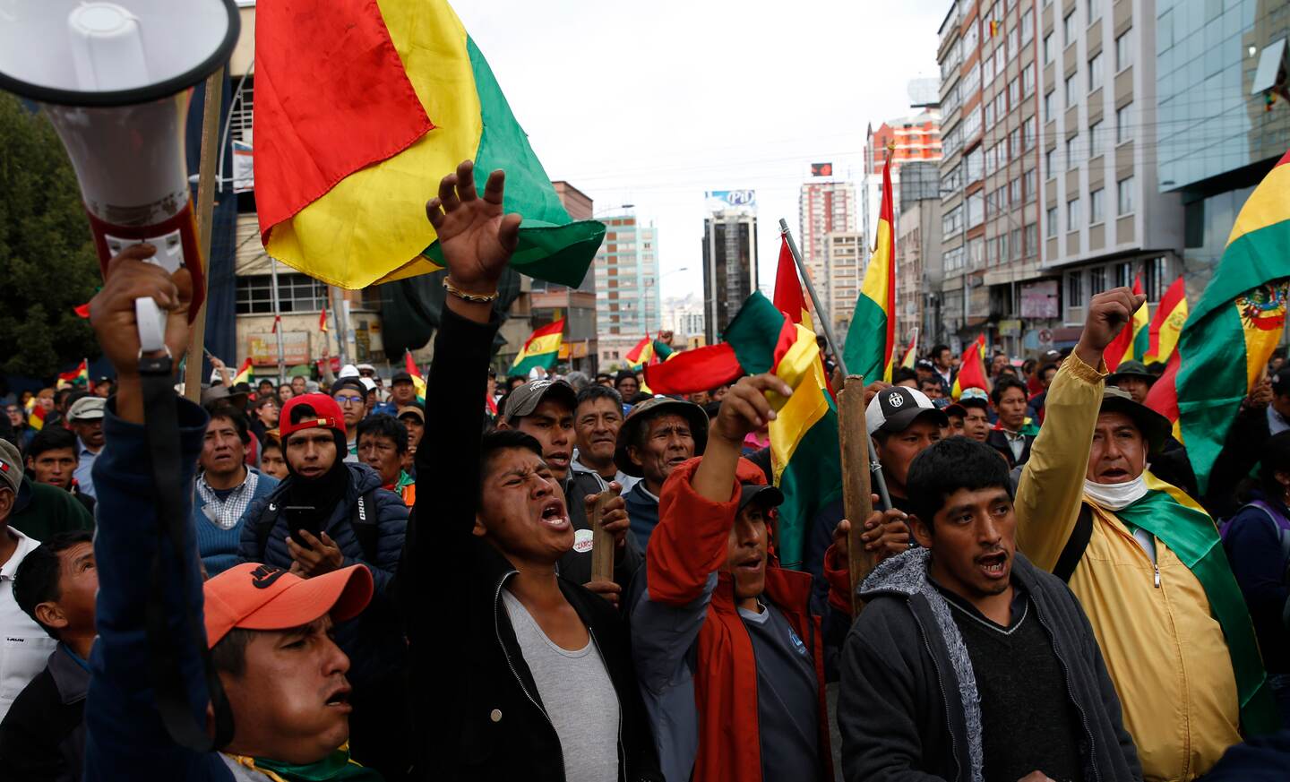 Coca leaf producers march against the reelection of President Evo Morales, in La Paz, Bolivia, Tuesday, Oct. 29, 2019. Morales' backers and foes are blocking streets and highways across the country in a dispute over official election results that show the leftist leader winning reelection without a runoff. (AP Photo/Juan Karita)