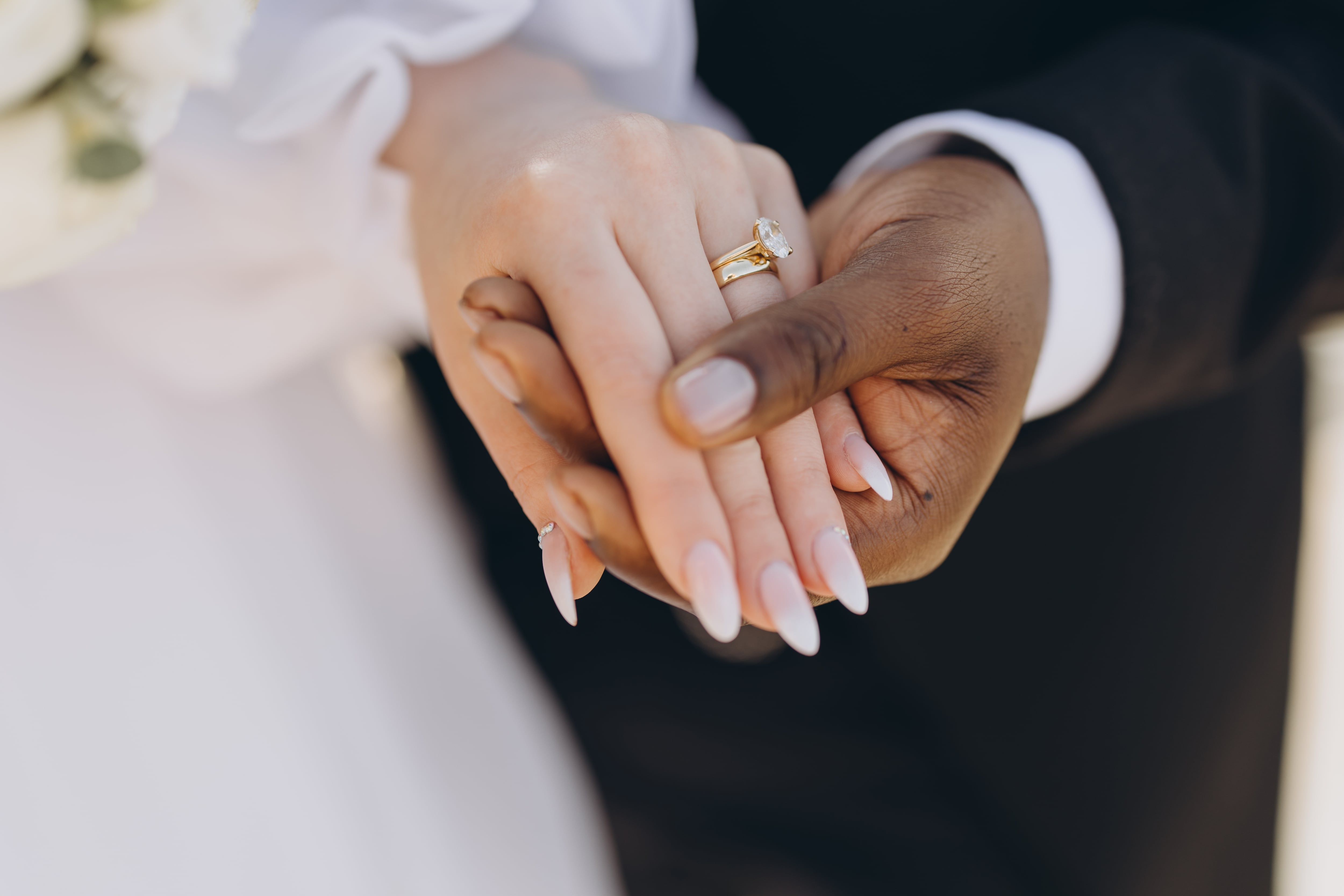 Bride,And,Groom,Holding,Hands,Showing,Wedding,Rings,,Celebrating,Interracial