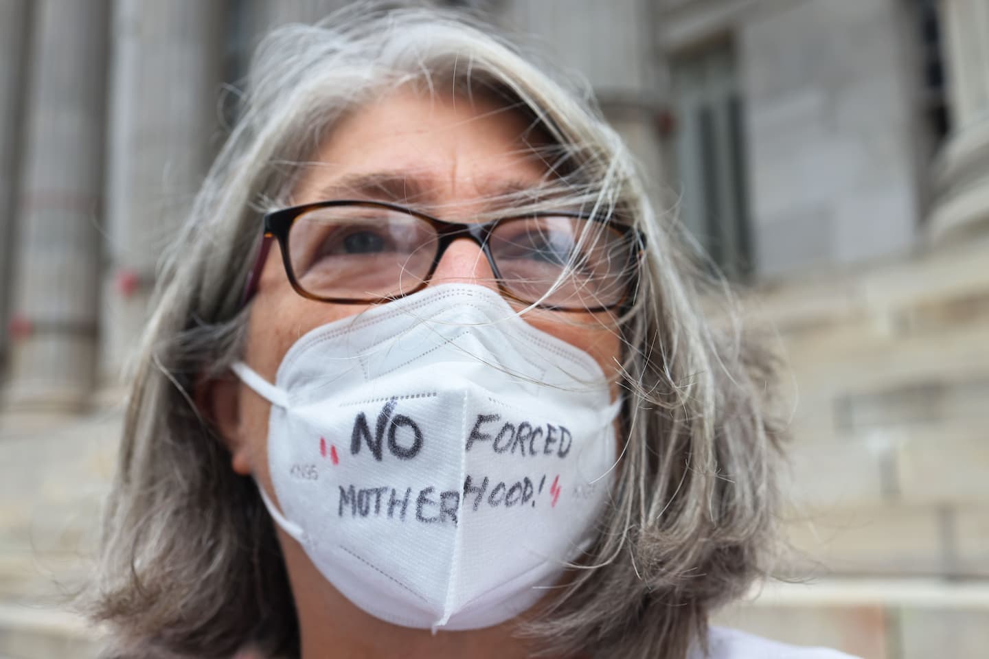 NEW YORK, NEW YORK - SEPTEMBER 01: Debra Sweet, weras a mask inscribed with the words " No Forced Motherhood" as she joins people gathered for a reproductive rights rally at Brooklyn Borough Hall on September 01, 2021 in Downtown Brooklyn in New York City. NOW-NYC and Planned Parenthood of Greater New York Action Fund organized a rally for reproductive rights after a Texas law that has been dubbed the "Heartbeat Bill" went into effect. The law ends access to abortion after six weeks of pregnancy and would allow anyone to sue abortion providers and �aiders and abetters� in civil court. Abortion rights activists have asked the Supreme Court to block the law, but as of Wednesday morning the court has allowed the law to go into effect. In May, Supreme Court justices agreed to review a Mississippi case on the state's ban on abortion procedures after 15 weeks of pregnancy, a direct challenge to Roe v. Wade, the 1973 landmark decision that legalized abortion nationwide. A ruling on that case is expected in 2022. Michael M. Santiago/Getty Images/AFP
== FOR NEWSPAPERS, INTERNET, TELCOS & TELEVISION USE ONLY ==