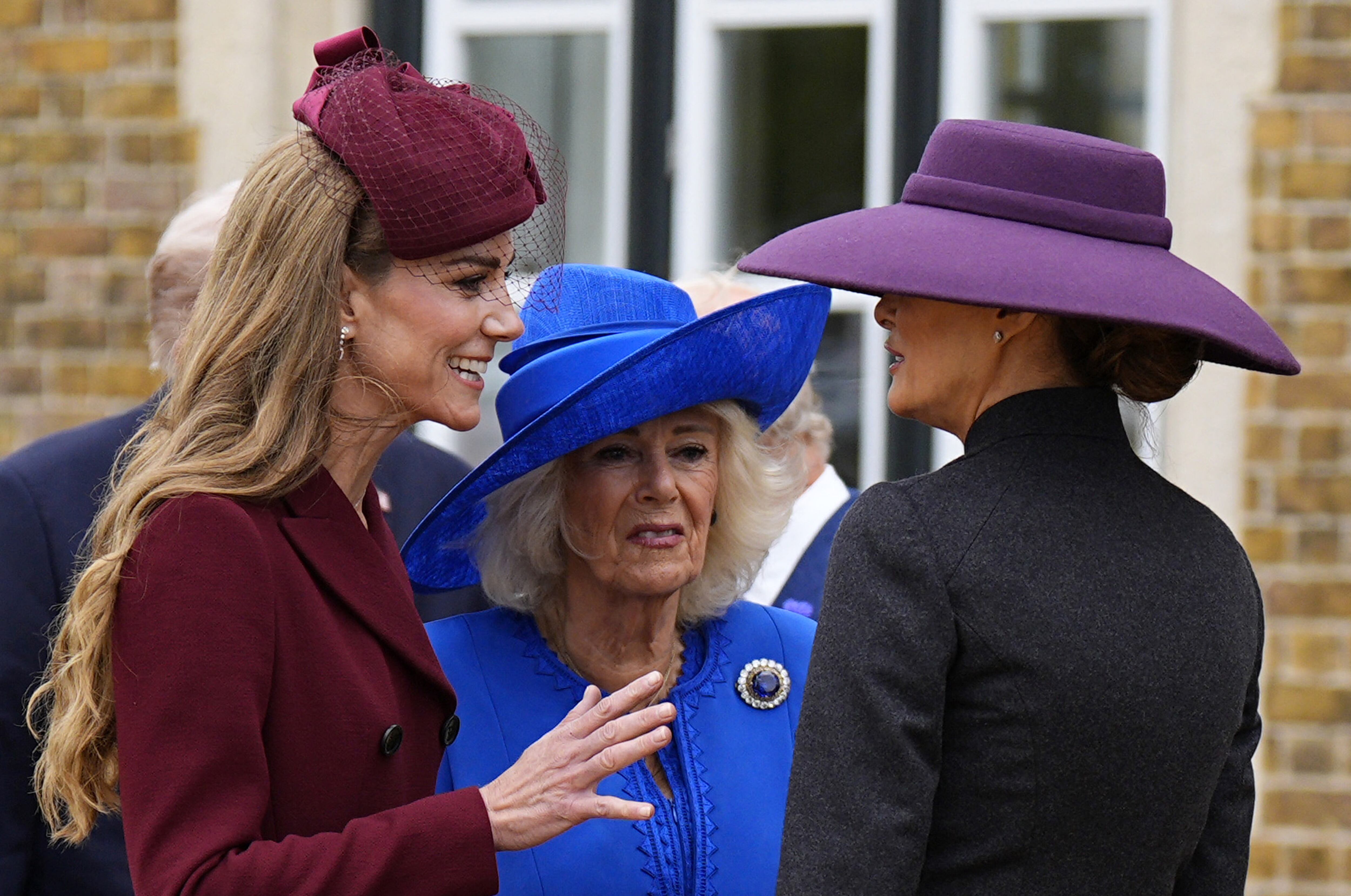 Britain's Queen Camilla and Britain's Catherine, Princess of Wales talk with US First Lady Melania Trump upon her arrival in the grounds of Windsor Castle, in Windsor, on September 17, 2025, for the start of a second State Visit. US President Donald Trump arrived in Britain for an unprecedented second State Visit, with the UK government rolling out a royal red carpet welcome to win over the mercurial leader. (Photo by Aaron Chown / POOL / AFP)