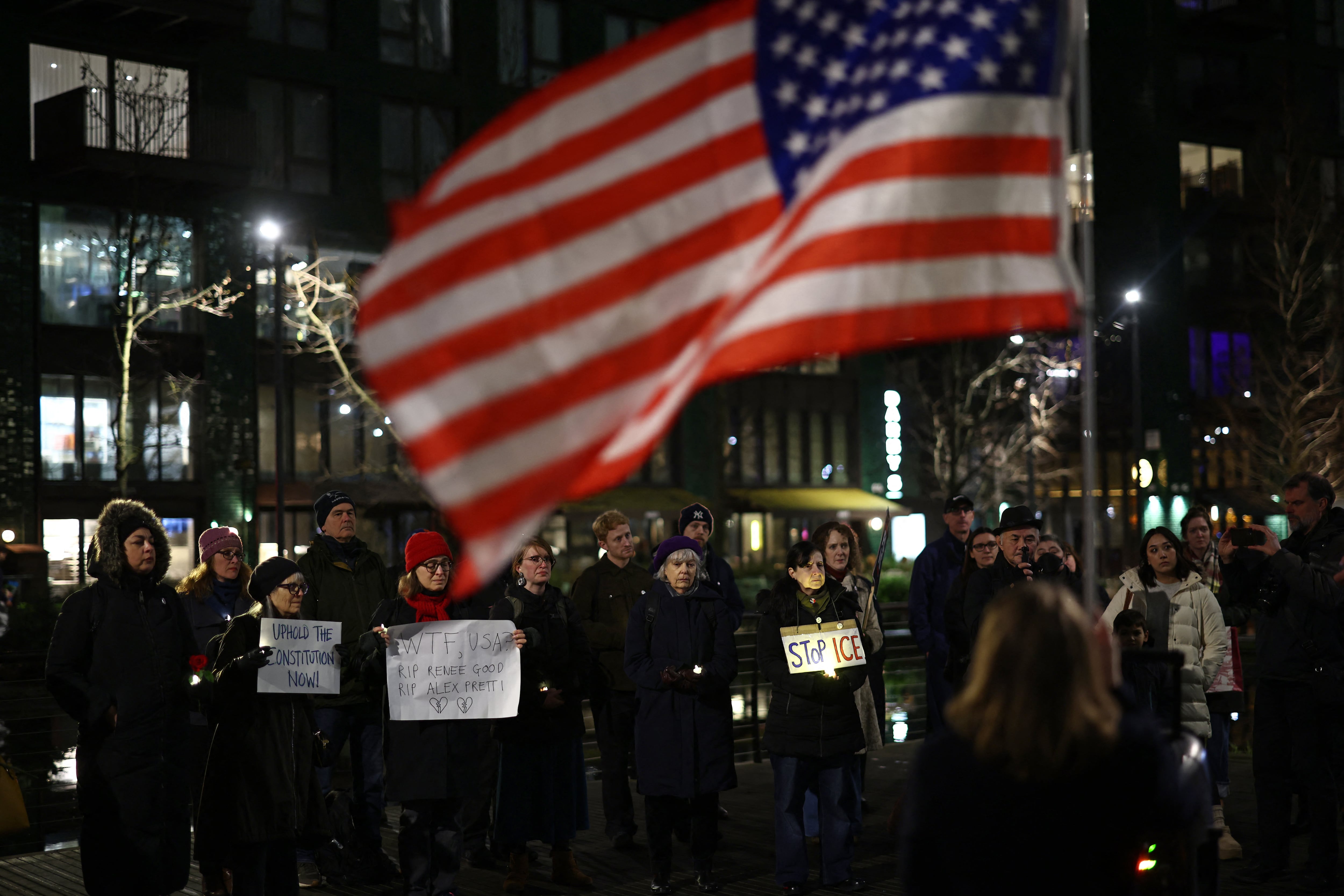 People hold signs and candles during a vigil for Alex Pretti, a 37-year-old nurse who was fatally shot by immigration agents in Minneapolis, outside the US Embassy in London on January 31, 2026. On January 24, US Border Patrol officers shot and killed 37-year-old nurse Alex Pretti on the fringes of a deportation raid in Minneapolis, Minnesota. Less than three weeks earlier, an ICE immigration officer shot and killed Renee Good, a mother of three, in the same city. (Photo by HENRY NICHOLLS / AFP)