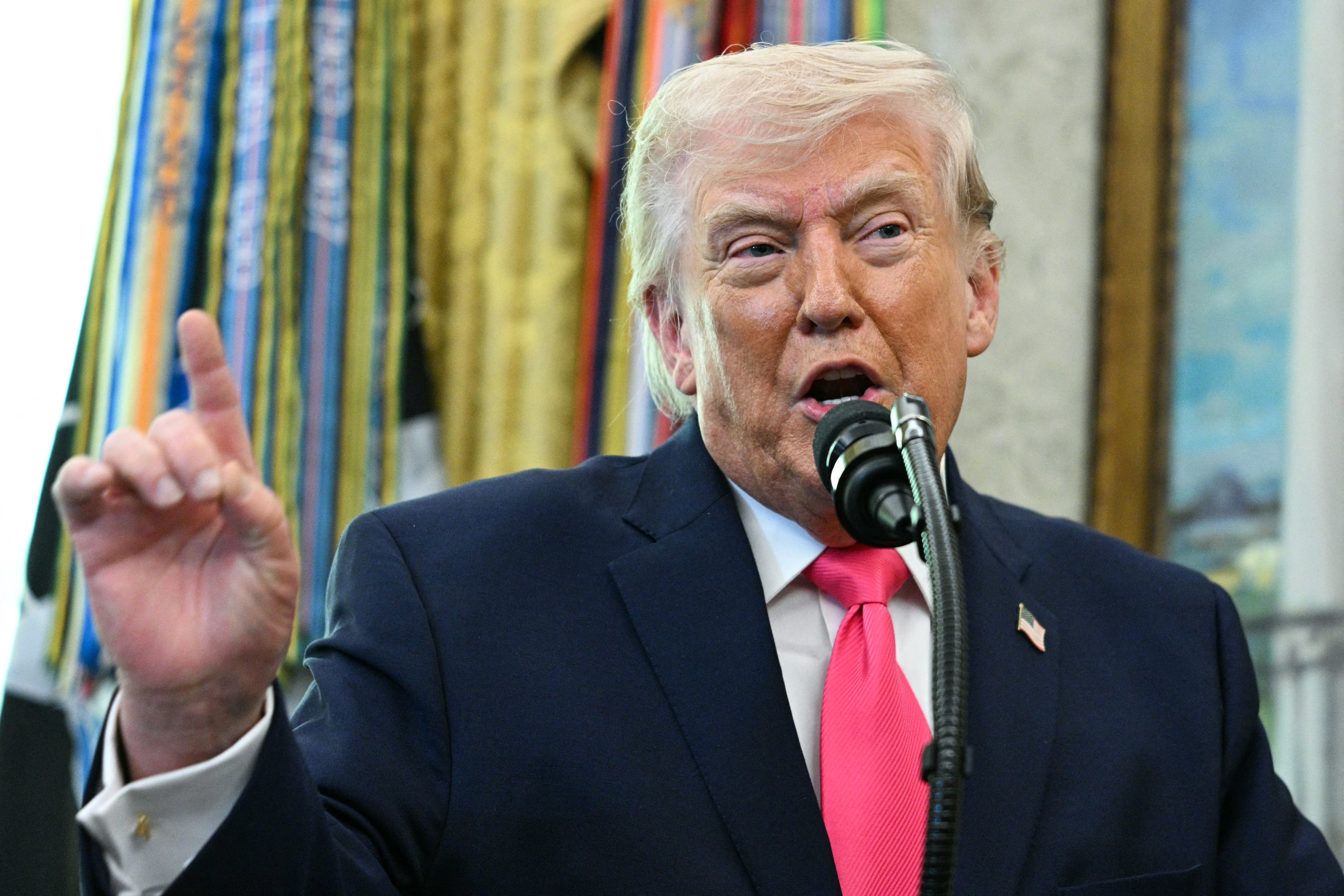 US President Donald Trump speaks during a swearing in ceremony for new Homeland Security Secretary Markwayne Mullin in the Oval Office of the White House in Washington, DC, on March 24, 2026. The US Senate on Monday confirmed Mullin as the new chief of the Department of Homeland Security (DHS), the agency reeling from a partial government shutdown as it works to enforce President Donald Trump's immigration crackdown. (Photo by Jim WATSON / AFP)