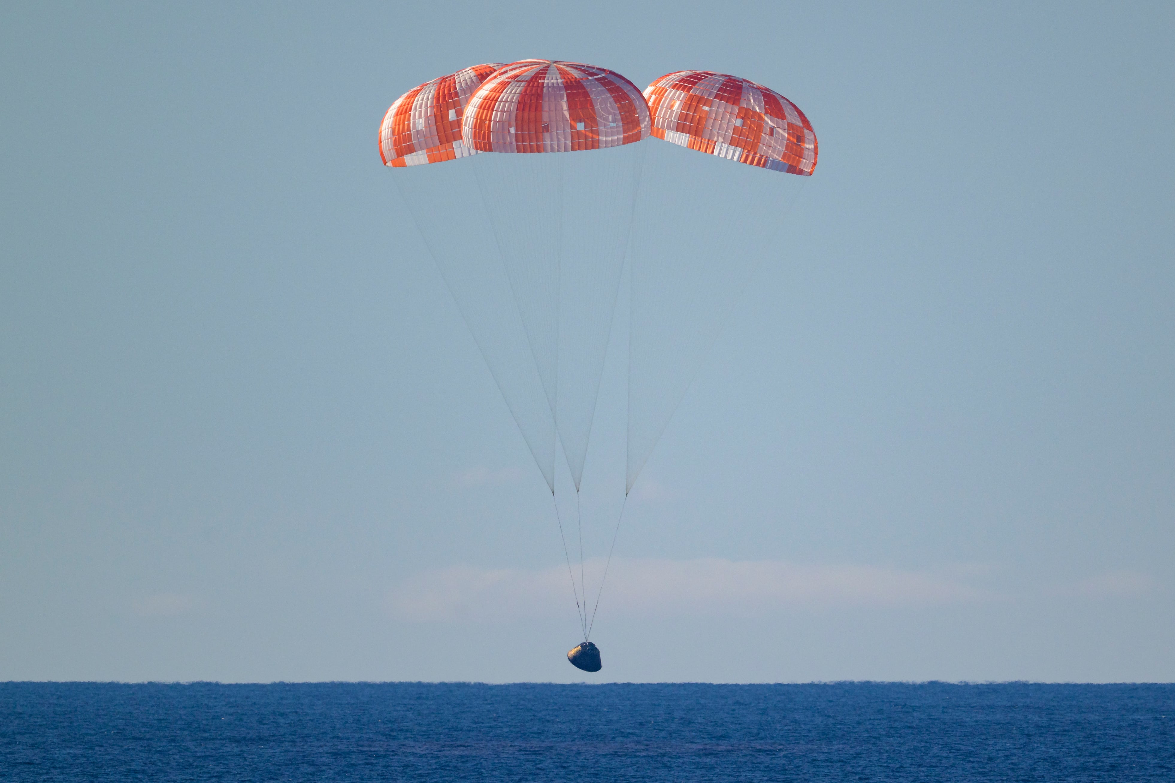 la nave espacial Orion de la NASA con los tripulantes de Artemis II: los astronautas de la NASA Reid Wiseman (comandante), Victor Glover (piloto), Christina Koch (especialista de misión) y el astronauta de la CSA (Agencia Espacial Canadiense) Jeremy Hansen (especialista de misión), mientras aterriza en el océano Pacífico frente a la costa de California, el 10 de abril de 2026.