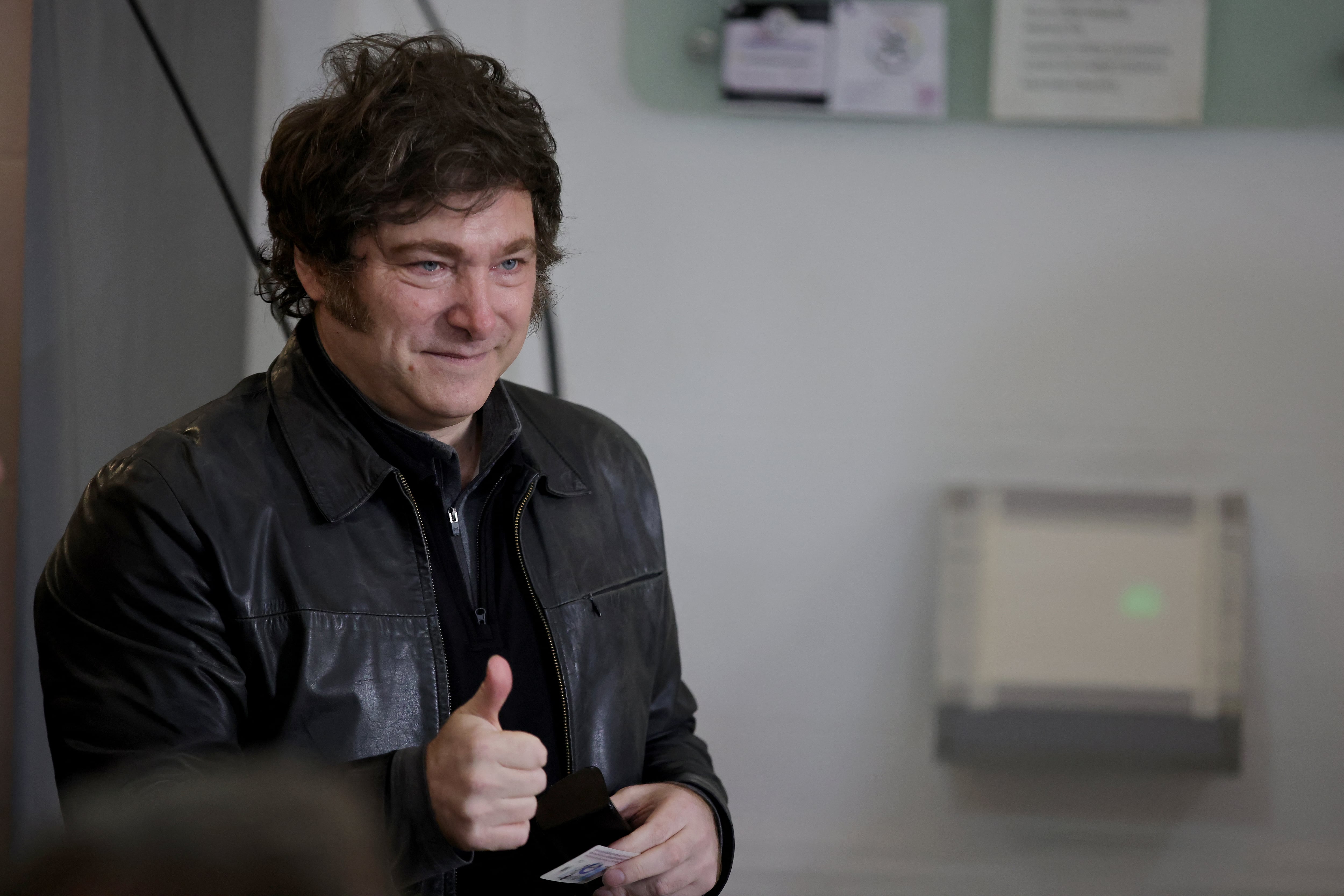 Argentina's President Javier Milei gives the thumb up before voting at a polling station during the legislative elections in the city of Buenos Aires on May 18, 2025. President Javier Milei's government faces a key date in Argentina's electoral calendar this Sunday, with the election of legislators in the city of Buenos Aires, in which it seeks to impose itself as the main right-wing option against a Peronism (opposition) that will try to take advantage of the fragmentation to win. (Photo by Emiliano Lasalvia / AFP)