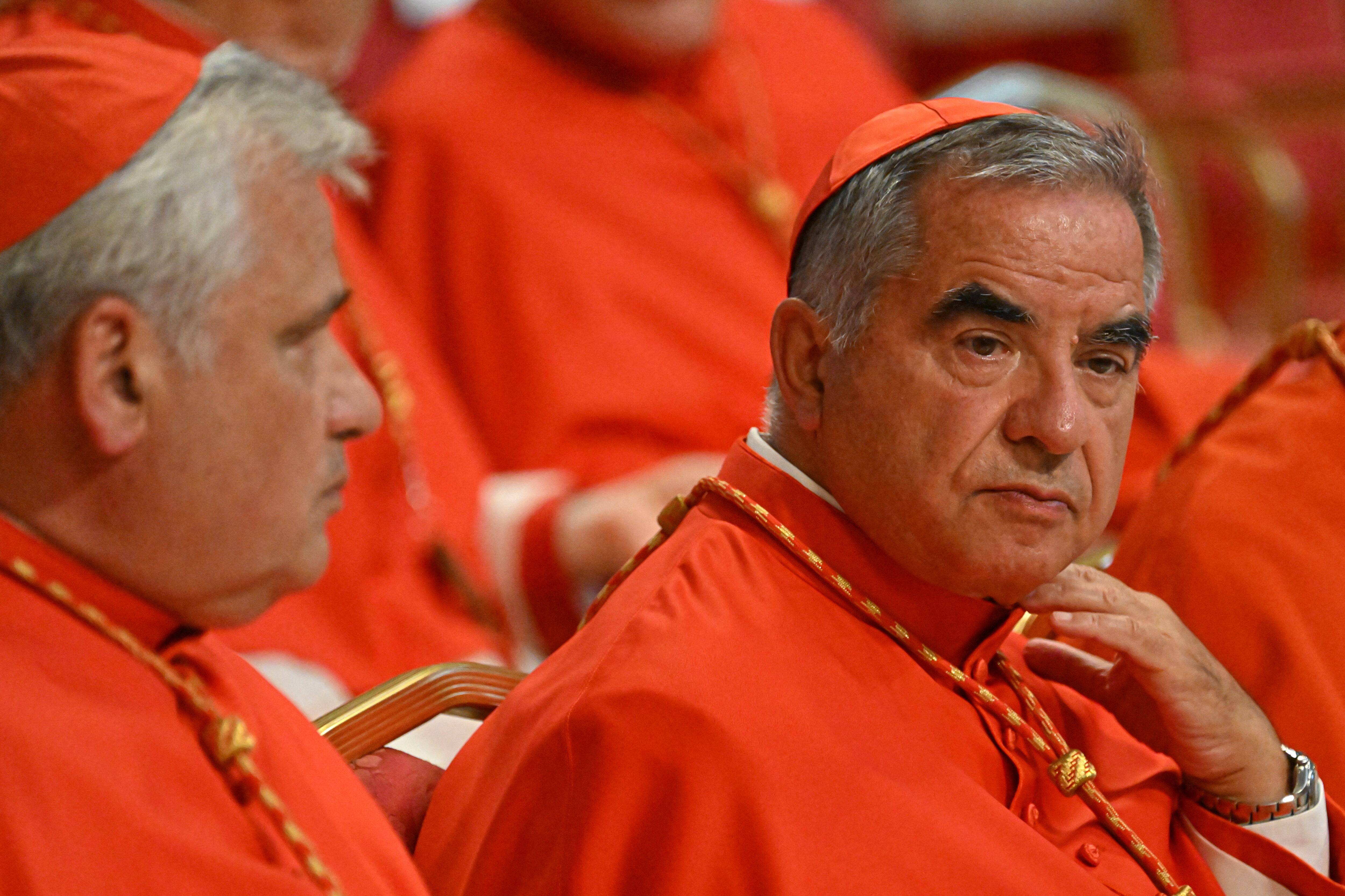 Italian Cardinal Giovanni Angelo Becciu (R) waits prior to the start of a consistory during which 20 new Cardinals are to be created by the Pope, on August 27, 2022 at St. Peter's Basilica in The Vatican. (Photo by Alberto PIZZOLI / AFP)