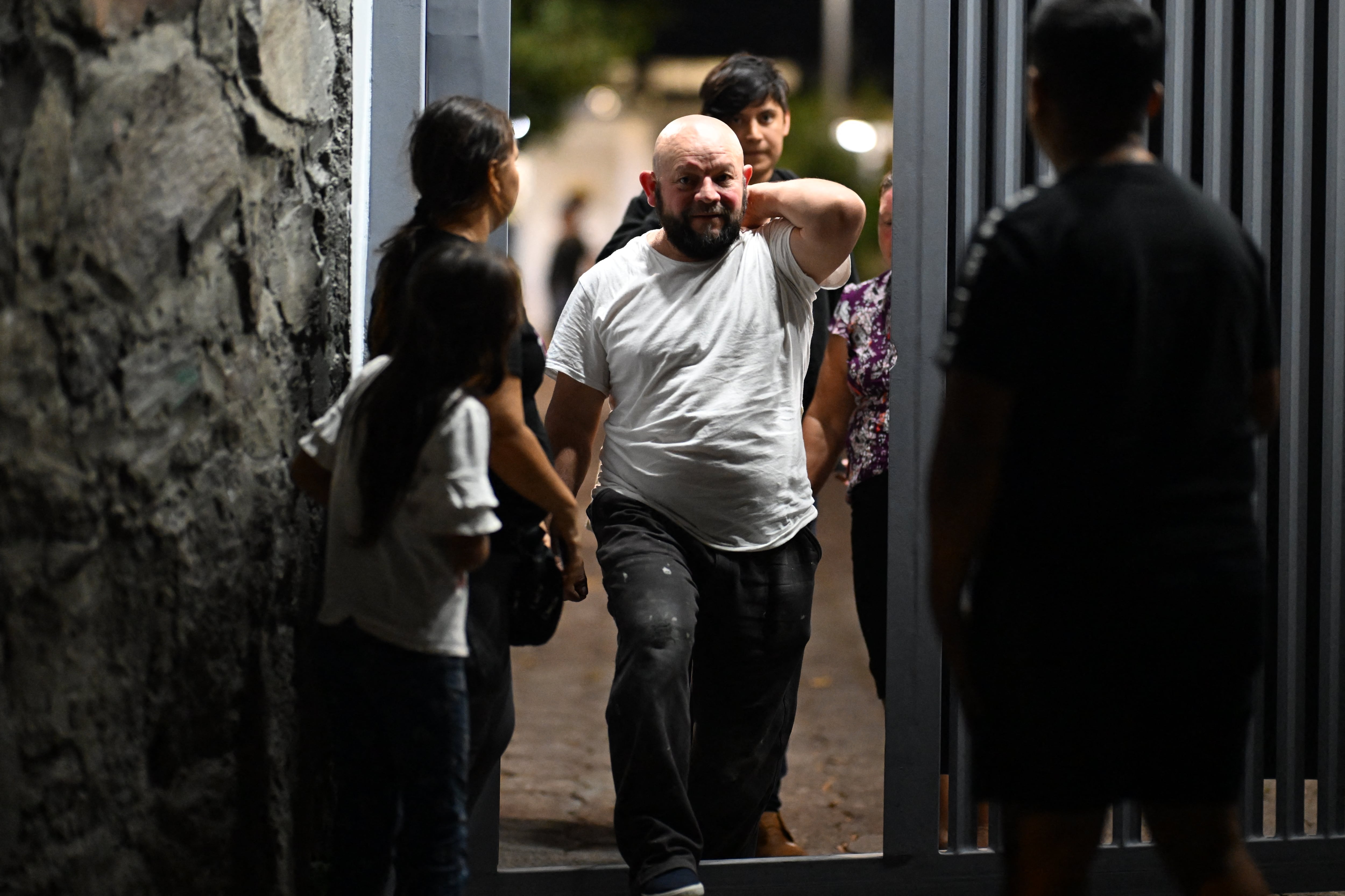 Jos� Maximino Amaya, a Salvadoran migrant deported from the United States, leaves the Center for the Care of Returned Migrants in San Salvador, El Salvador, on February 26, 2025. From one day to the next Jose Maximino Amaya lost everything: his car, household goods, and the proximity of his three children, from whom he was separated when he was deported from the United States. The 50-year-old El Salvador native, who was detained a month ago, was among several dozen citizens of the Central American country who were returned to their homeland Wednesday by US President Donald Trump's administration. (Photo by Marvin RECINOS / AFP)