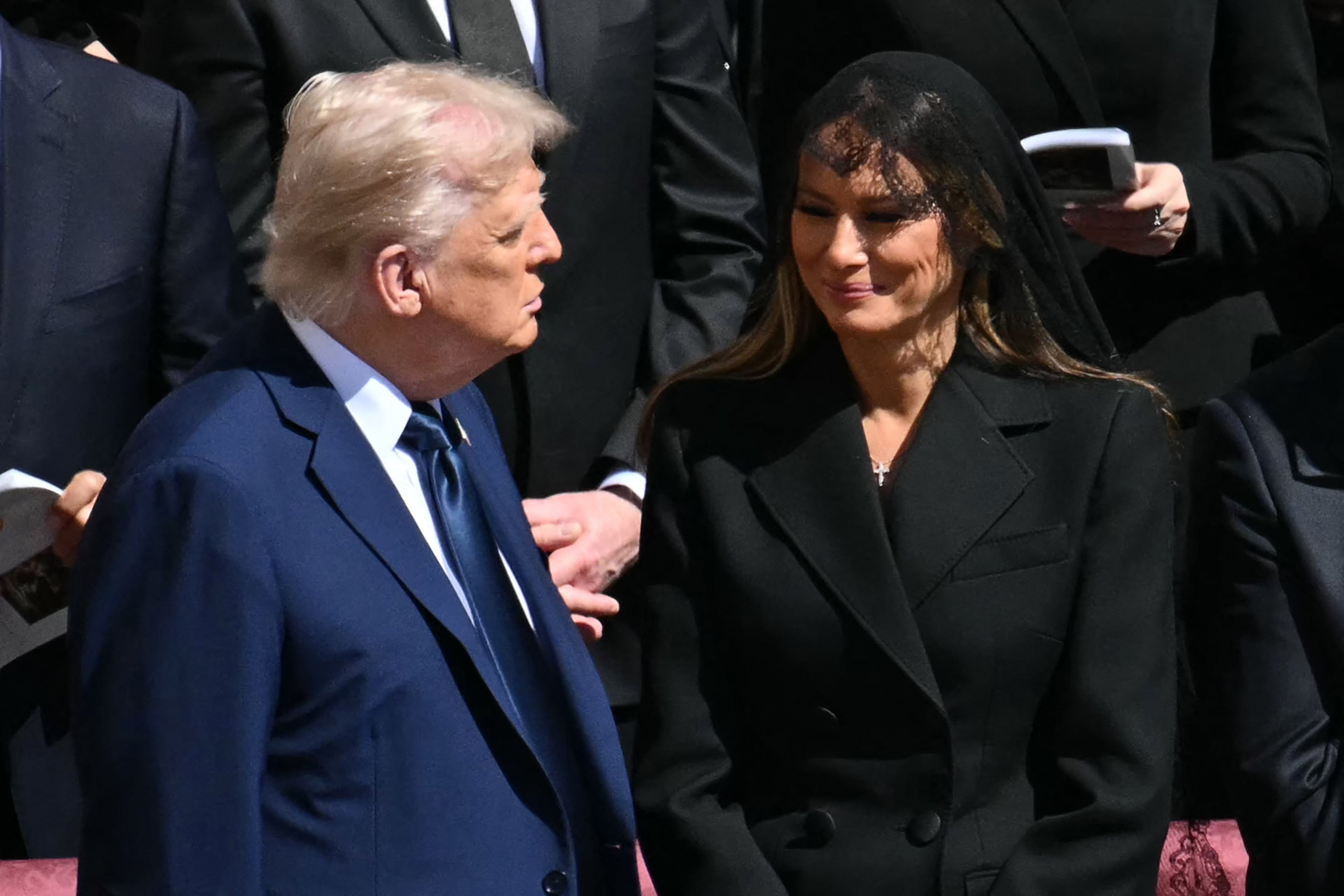 US President Donald Trump (L) and First Lady Melania Trump stand alongside leaders as they attend the late Pope Francis' funeral ceremony at St Peter's Square at the Vatican on April 26, 2025. (Photo by Mandel NGAN / AFP)