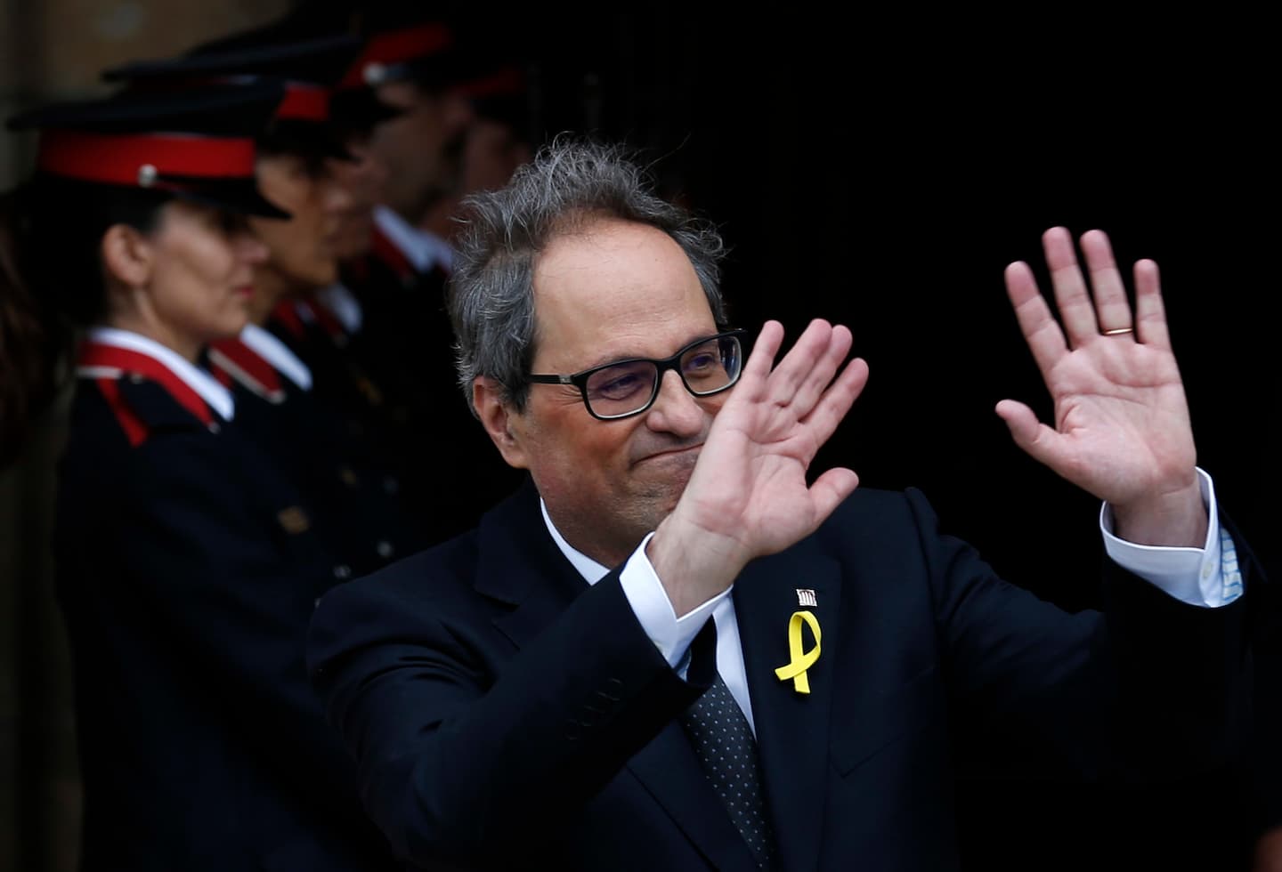 Newly appointed Catalan president Quim Torra, leaves the parliament after a parliamentary vote session in Barcelona, Spain, Monday, May 14, 2018. Catalan lawmakers have ended a half-year power vacuum by electing in a close vote secession enthusiast Quim Torra as the new regional chief, a controversial figure for the unionist opposition. (AP Photo/Manu Fernandez)