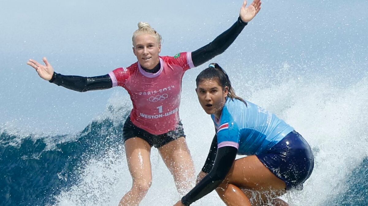 TEAHUPO'O, FRENCH POLYNESIA - AUGUST 5: Tatiana Weston-Webb (L) of Brazil reacts as Brisa Hennessy of Costa Rica drops in on her in the women's surfing semi-finals of the Paris 2024 Olympic Games August 5, 2024 in Teahupo'o, on the French Polynesian Island of Tahiti. (Photo by Ben Thouard-Pool/Getty Images)