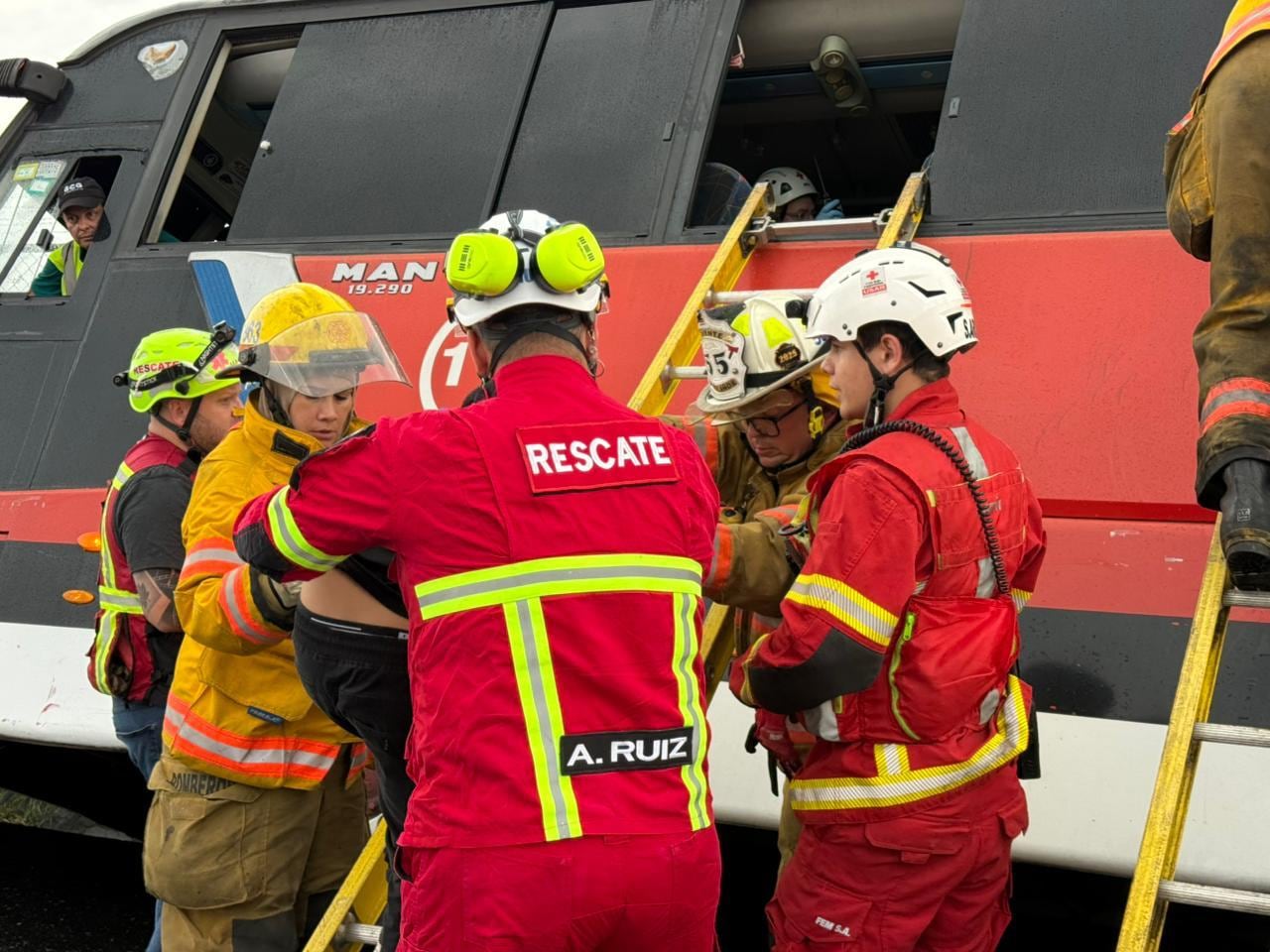 Unidades de Cruz Roja y Bomberos atendieron el vuelco de un bus de Tuasa sobre la malla del aeropuerto Juan Santamaría.