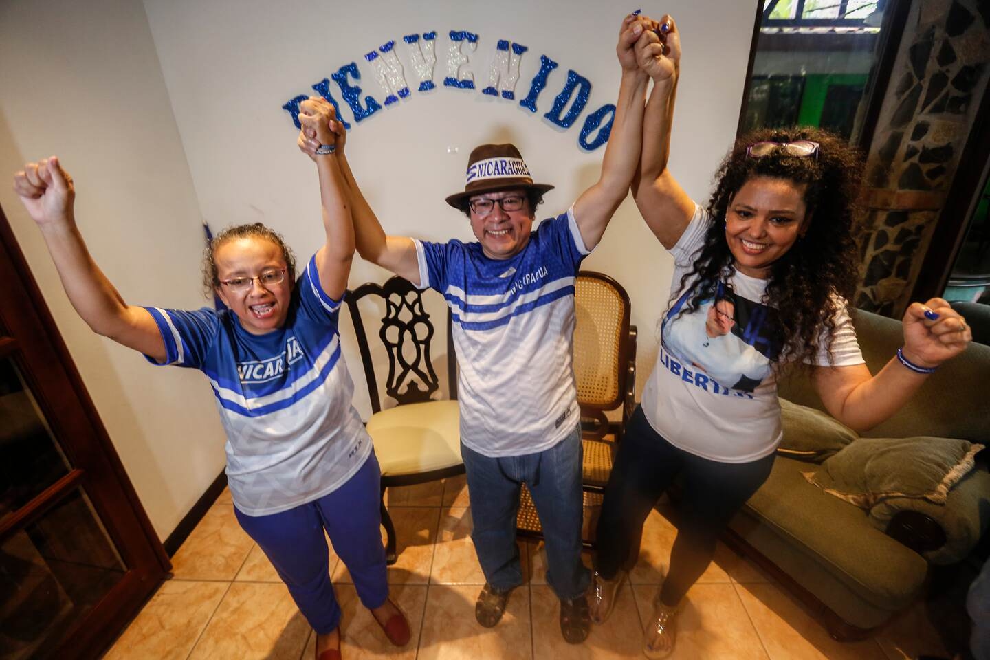 Journalists Lucía Pineda, left, and Miguel Mora, center, celebrate their release from prison, accompanied by Mora's wife Veronica Chavez, at their home in Managua, Nicaragua, Tuesday, June 11, 2019. Mora's and Pineda's release comes amid a broader move to set free people the opposition considers political prisoners under an agreement meant to ease the country's political standoff. (AP Photo/Alfredo Zuñiga)