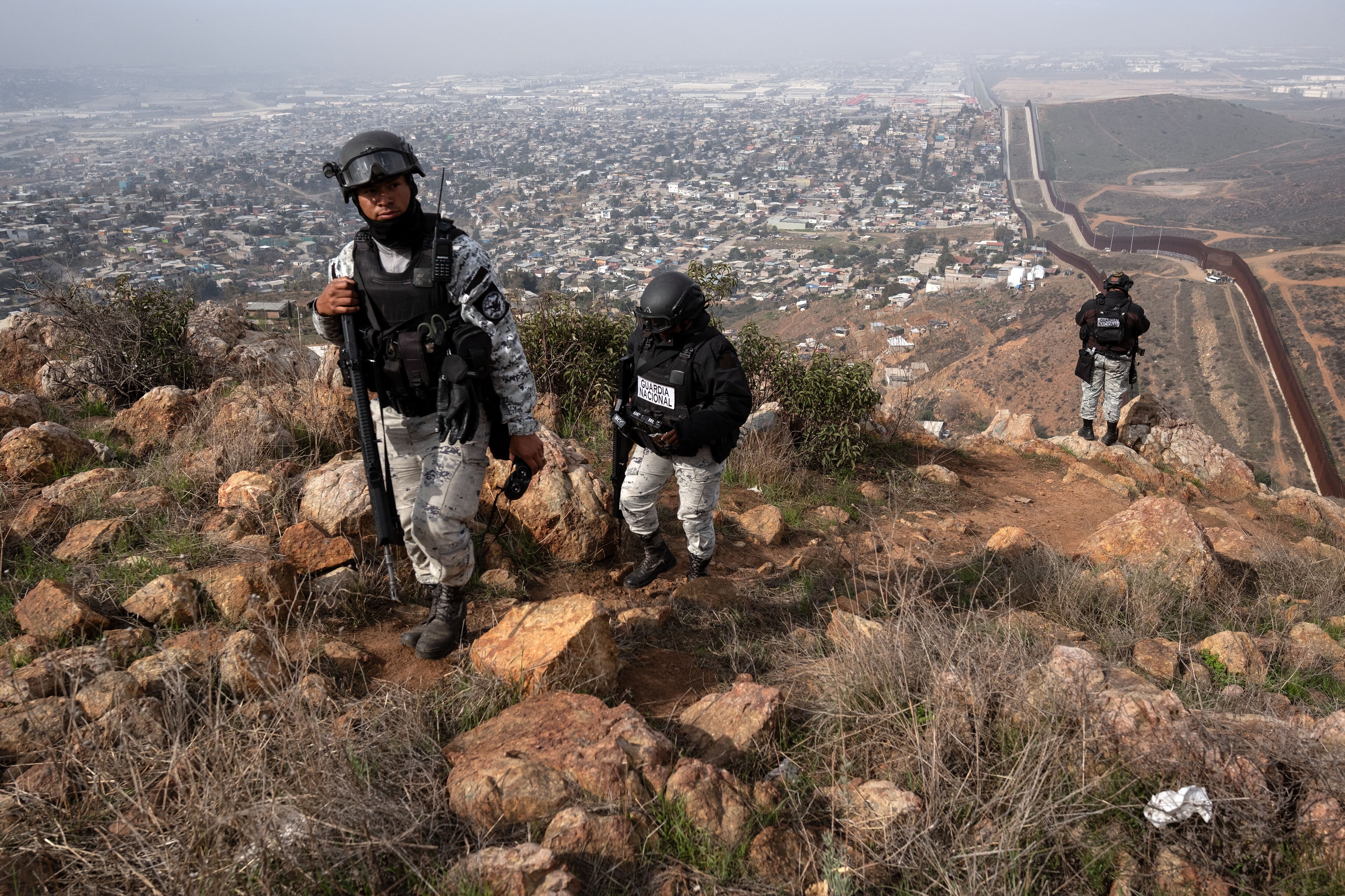 Mexican National Guard officers patrol at a high point of El Nido de las Aguilas in eastern Tijuana, Baja California State, Mexico, on March 5, 2025, on the Mexican side of the Mexico-US border. (Photo by Guillermo Arias / AFP)