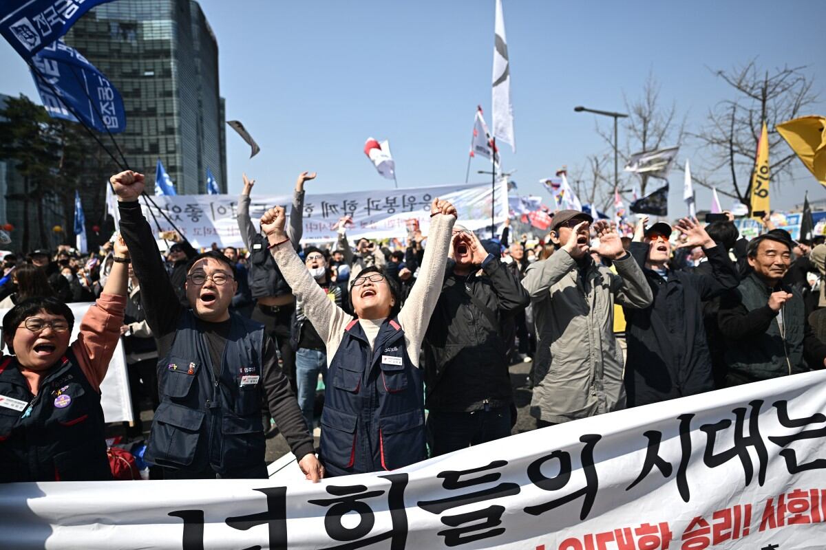 Anti-Yoon protesters react after the Constitutional Court's verdict on the impeachment of South Korea president Yoon Suk Yeol in Seoul on April 4, 2025. South Korea's Constitutional Court on April 4 upheld the impeachment of President Yoon Suk Yeol, stripping him of office over his disastrous declaration of martial law. (Photo by Pedro Pardo / AFP)