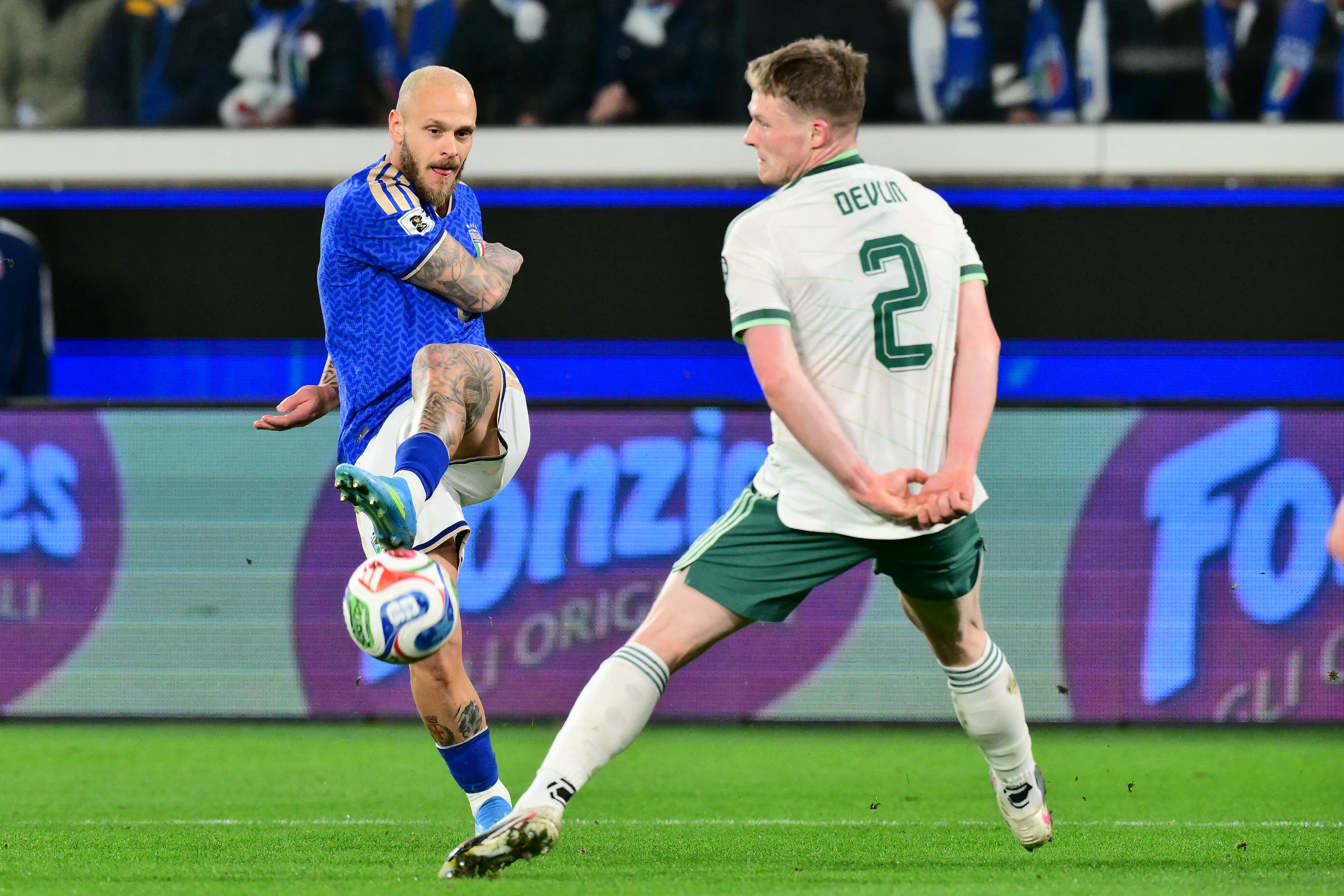 El delantero italiano Manuel Locatelli remata ante el irlandés Terry Devlin, durante el inicio del repechaje rumbo al Mundial 2026.