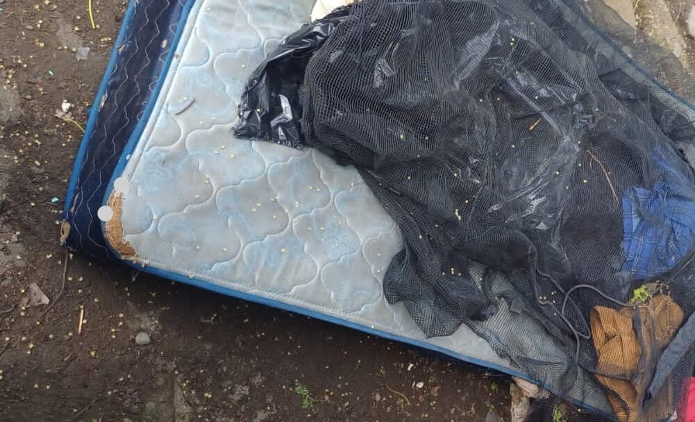 En ese viejo colchón y envuelto con plásticos y un sarán fue hallado este sábado en Cieneguita el cuerpo de un hombre apuñalado en tórax y cuello. Foto: sumnistrada por Reiner Montero.