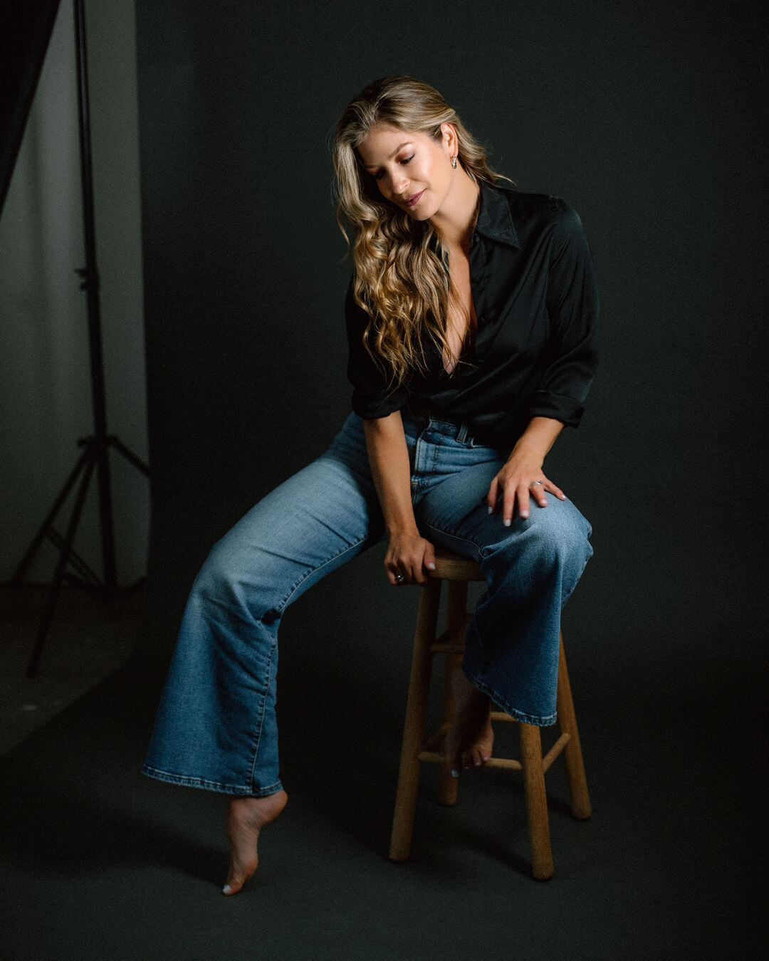 Viviana Calderón posando para la foto, usa el cabello suelto, blusa negra y jeans.
