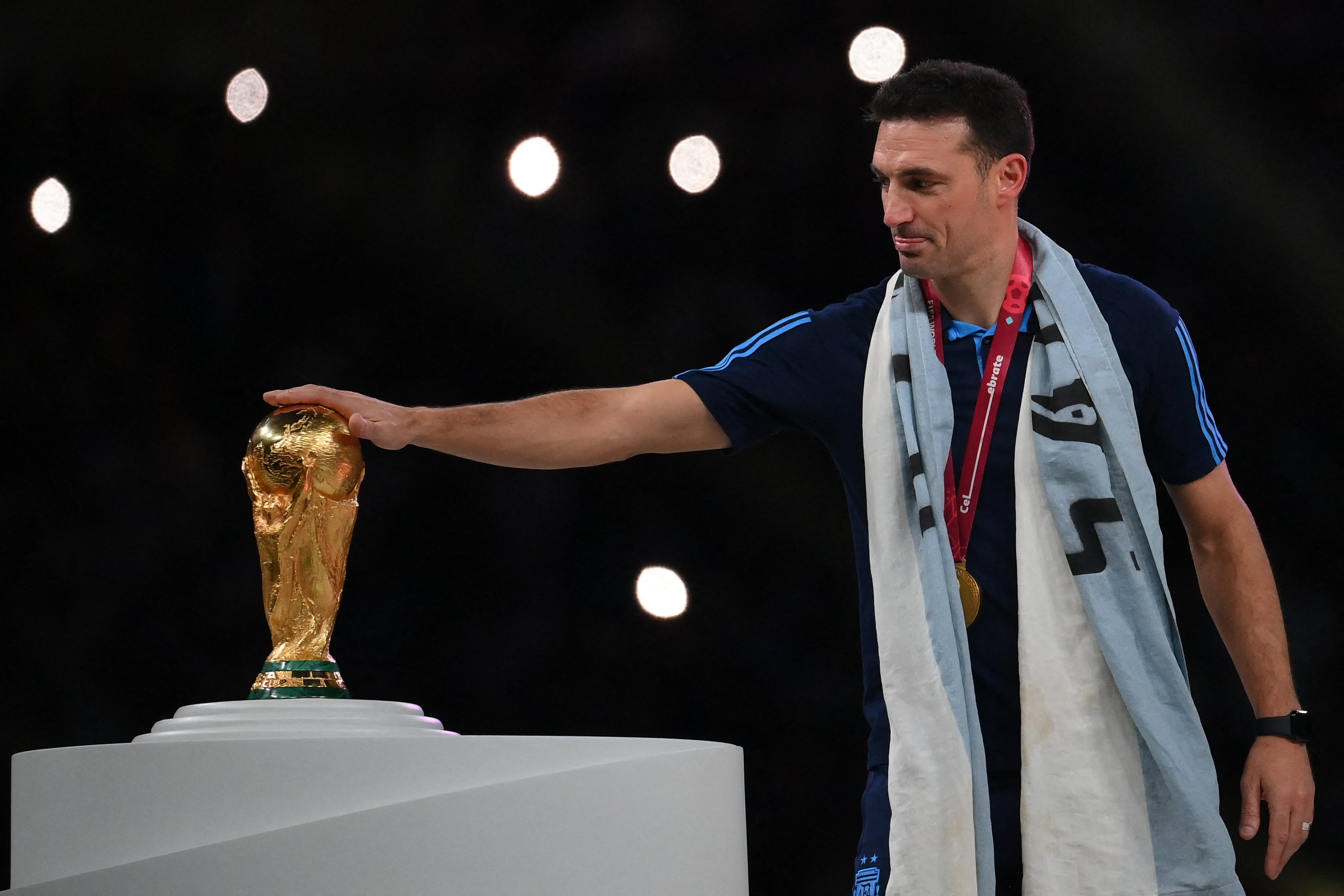 El entrenador de Argentina Lionel Scaloni toca el trofeo del Mundial luego de ganar la final del 2022 en Qatar, ante Francia.
