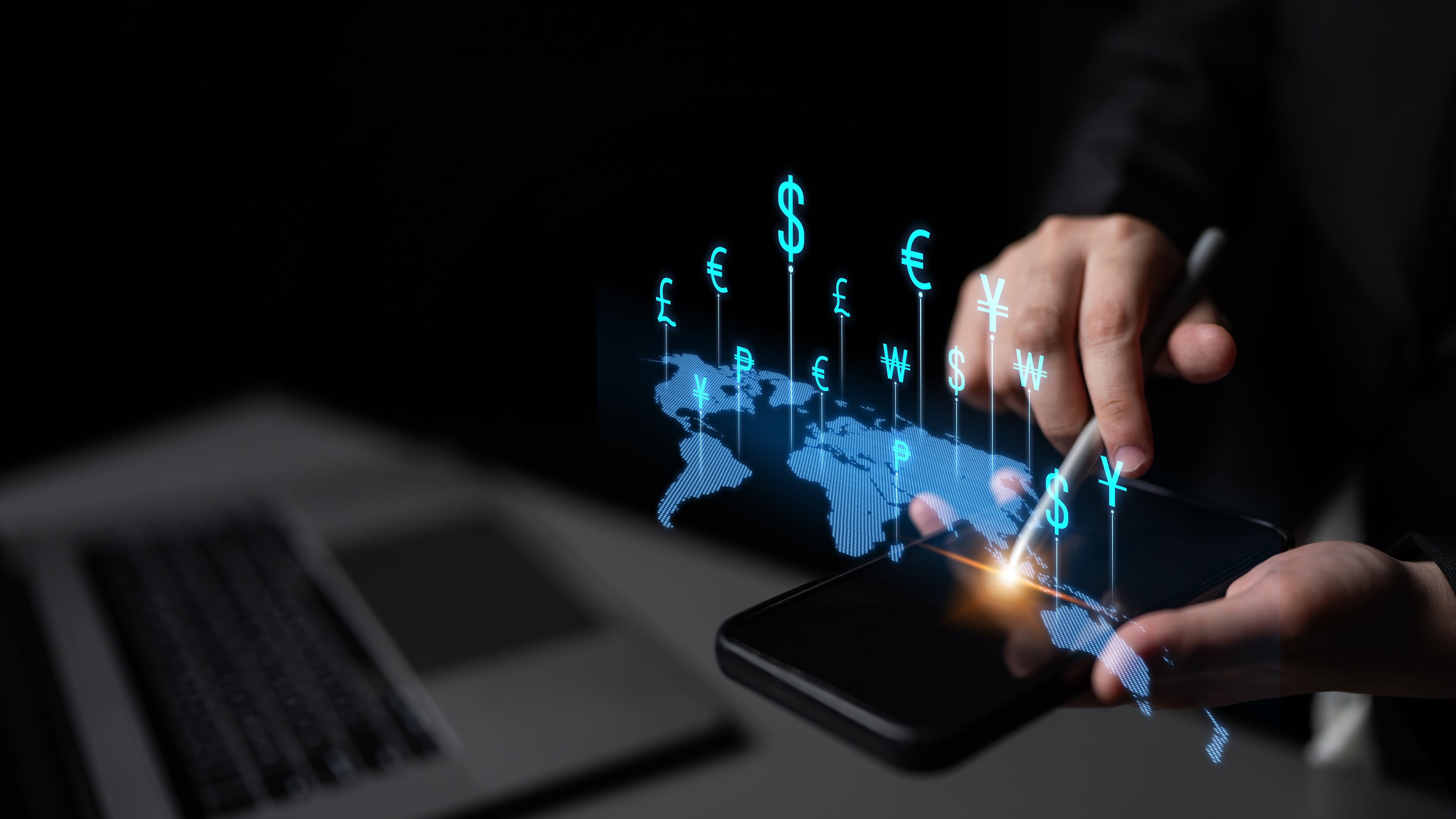 Mano usando dispositivo móvil con mapa global y símbolos de monedas que representan inversión extranjera directa, reinversión de utilidades y flujo de capital en Costa Rica