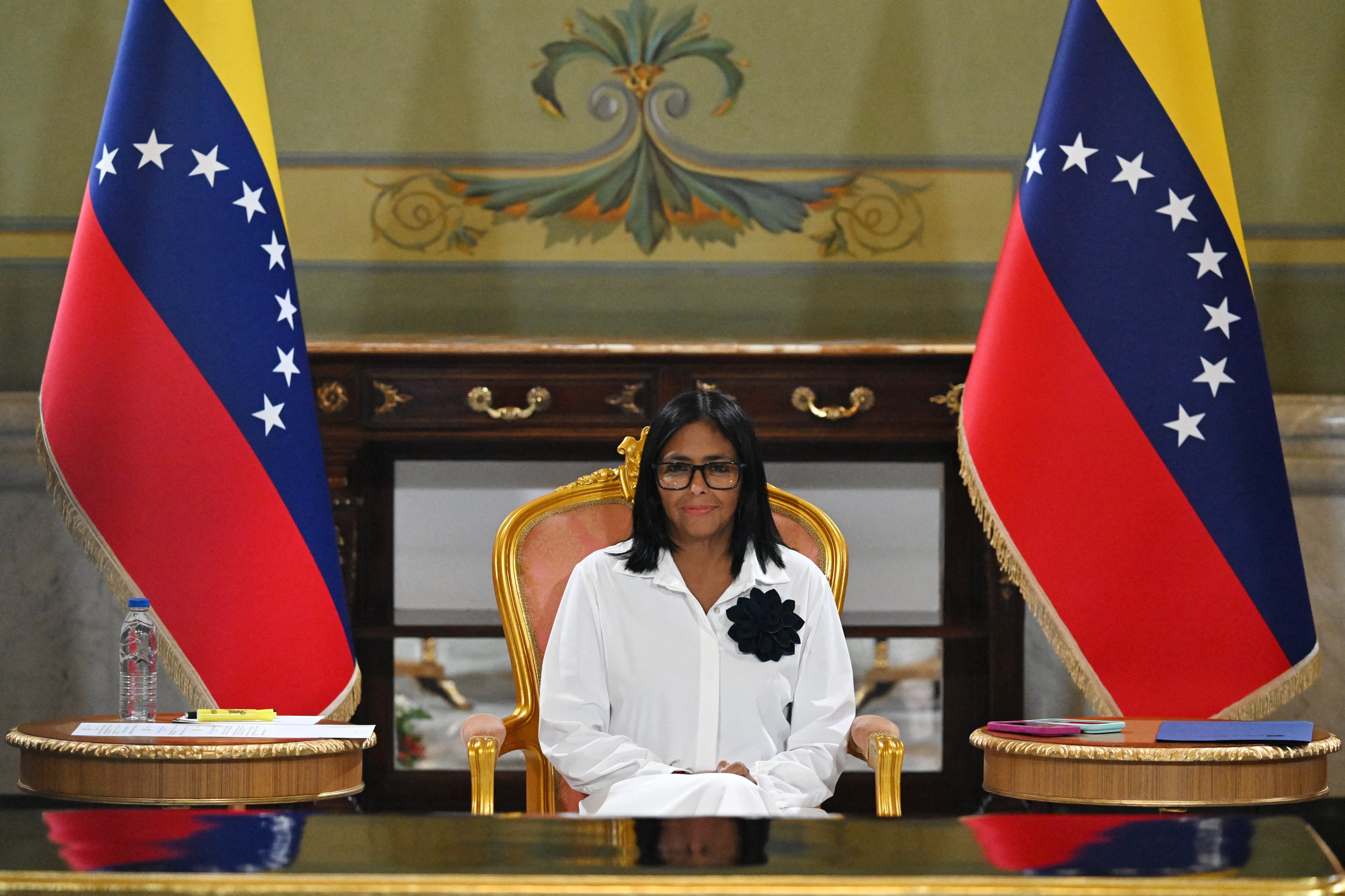 Venezuela's interim President Delcy Rodriguez looks on during a signing of an agreement ceremony between Chevron Venezuela and the national government at the Miraflores Palace in Caracas on April 13, 2026. Venezuela�s interim president, Delcy Rodriguez, praised on April 13 the progress made in the oil sector regarding foreign investment as part of the signing of agreements with the U.S. giant Chevron to increase crude oil production. (Photo by Juan BARRETO / AFP)