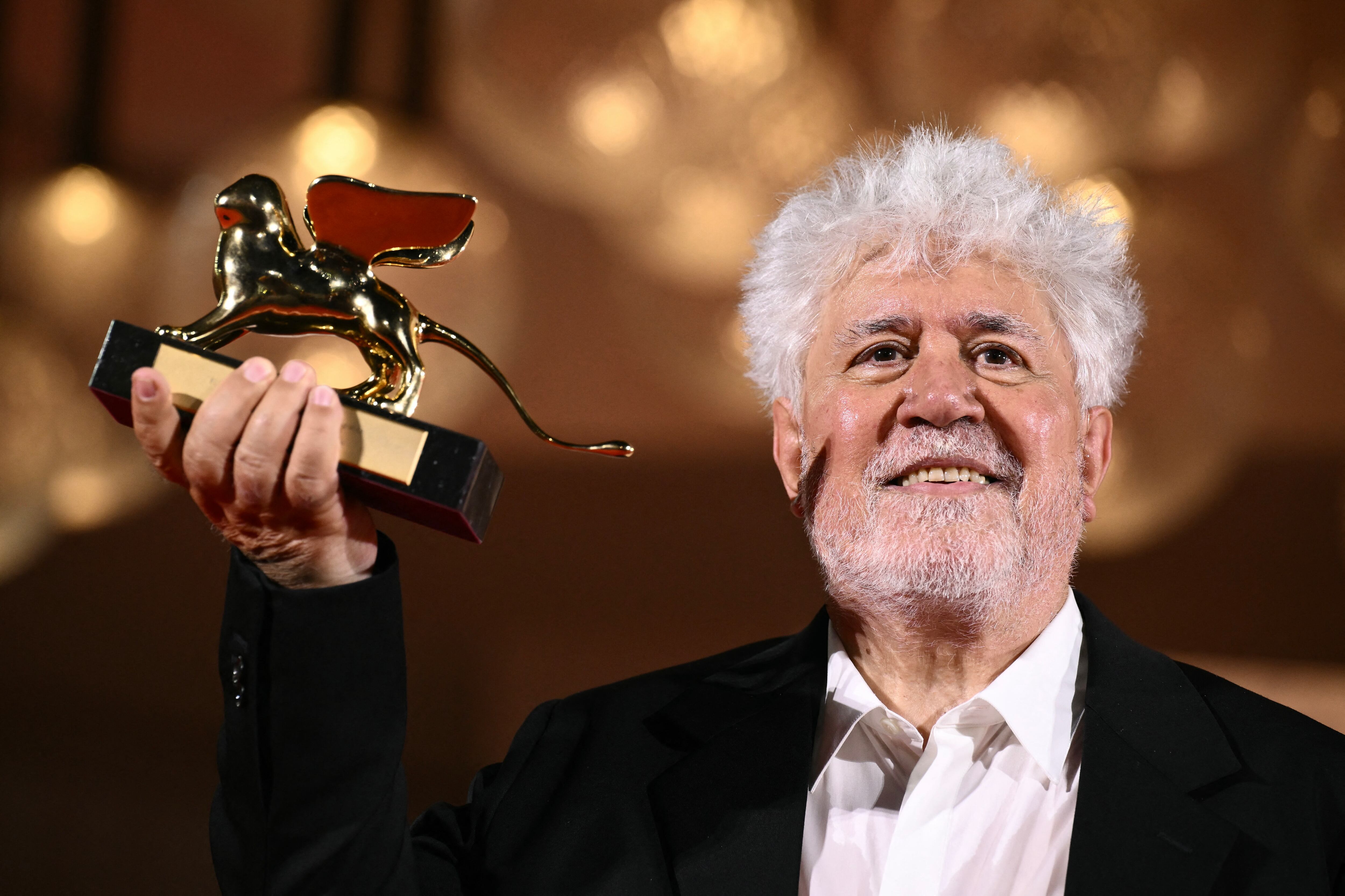 Spanish director Pedro Almodovar poses with the Golden Lion for Best Film he reveived for 'The Room Next Door' during a photocall following the award ceremony of the 81st Venice Film Festival on September 7, 2024 at Venice Lido. (Photo by Marco BERTORELLO / AFP)
