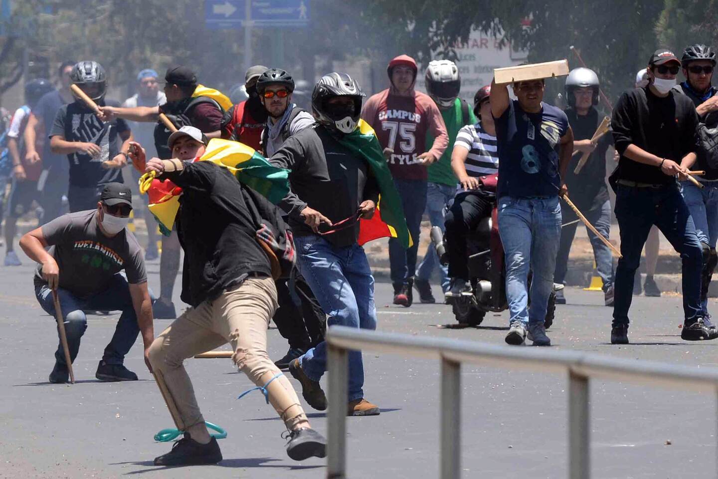 Supporters of defeated presidential candidate Carlos Mesa clash with those of Bolivian President Evo Morales over contested election results which the opposition claims are a fraud, in Cochabamba, Bolivia, on October 29, 2019. - Bolivia's government on Tuesday invited Mesa to take part in an audit of hotly disputed election results that sparked more than a week of riots amid accusations of fraud favouring the incumbent. President Evo Morales was re-elected in a controversial October 20 vote that featured a sudden and unexplained vote tally shift that benefitted the 60-year-old socialist leader. (Photo by STR / AFP)