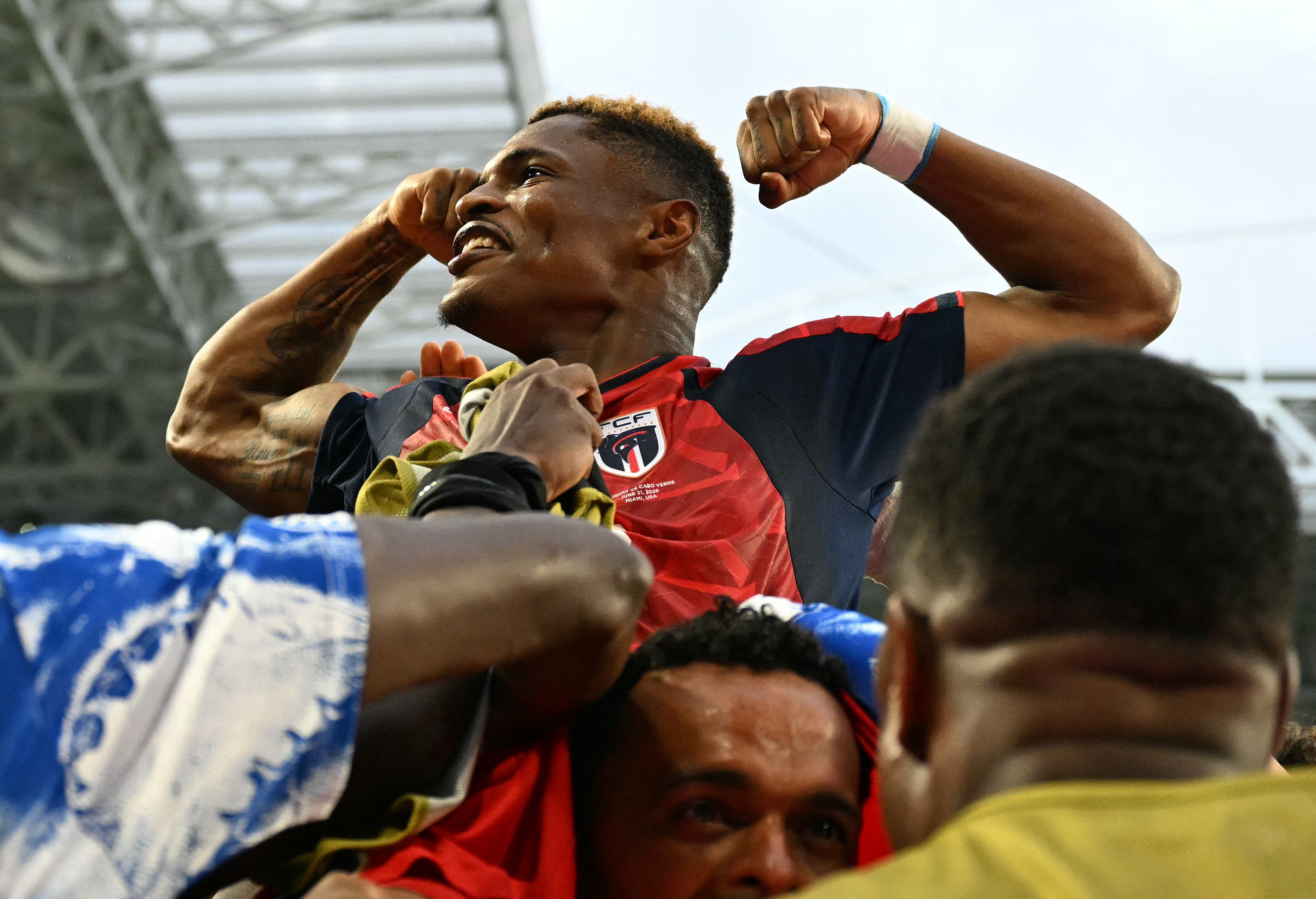 Cape Verde's forward #26 Helio Varela celebrates with teammates after scoring his team's second goal during the 2026 World Cup Group H football match between Uruguay and Cape Verde at the Miami Stadium in Miami Gardens on June 21, 2026. (Photo by CHANDAN KHANNA / AFP)