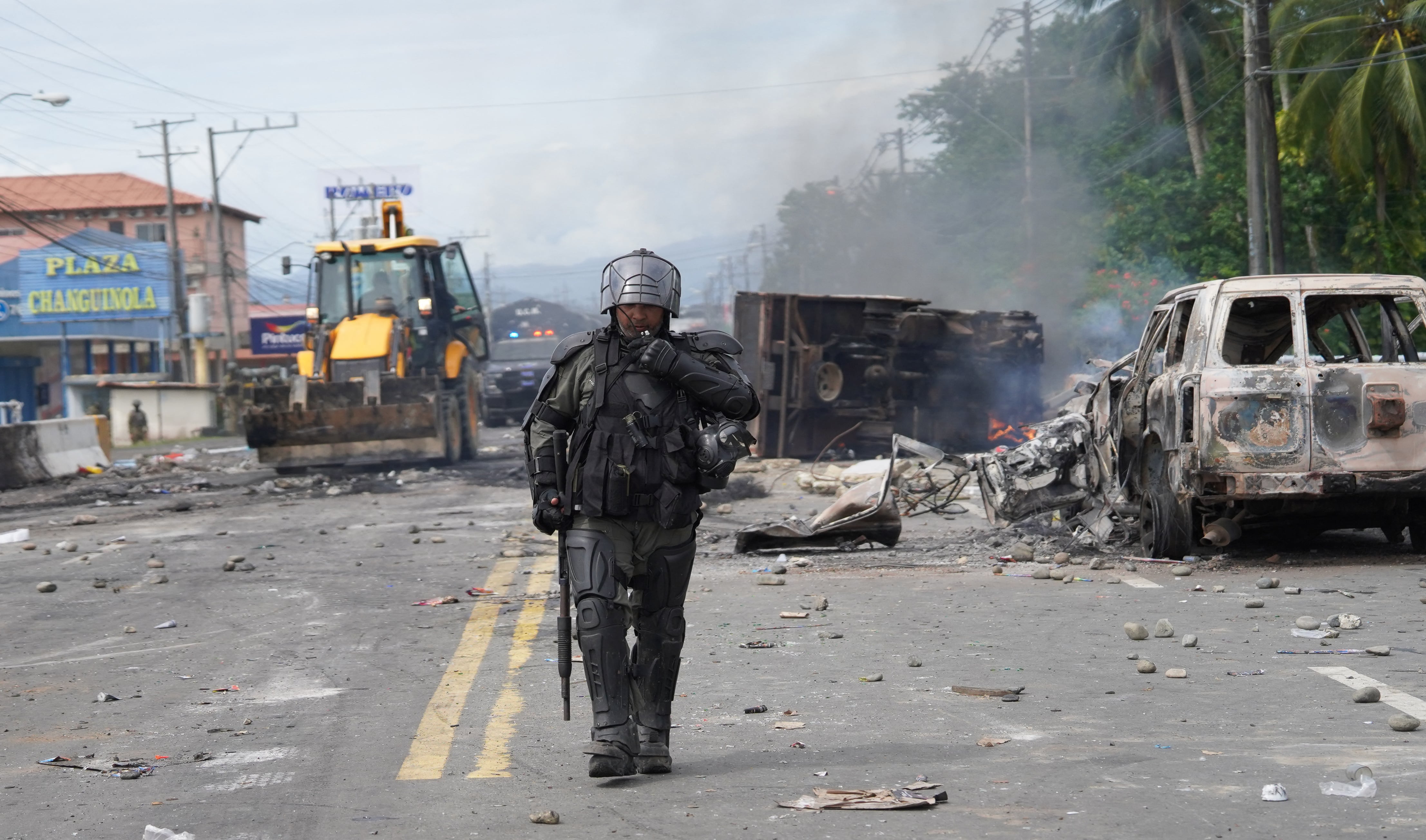 A man takes photographs of damages in a store in the city of Changuinola, Bocas del Toro, on June 20, 2025, after groups of vandals stormed the local airport, looted rental vehicles and various office items, and destroyed commercial properties, according to a police statement. Panama's President Jose Raul Mulino announced he will take "constitutional measures" to curb the ongoing wave of protests and road blockades that have affected the Caribbean province of Bocas del Toro for over a month. (Photo by DANIEL SANTOS / AFP)