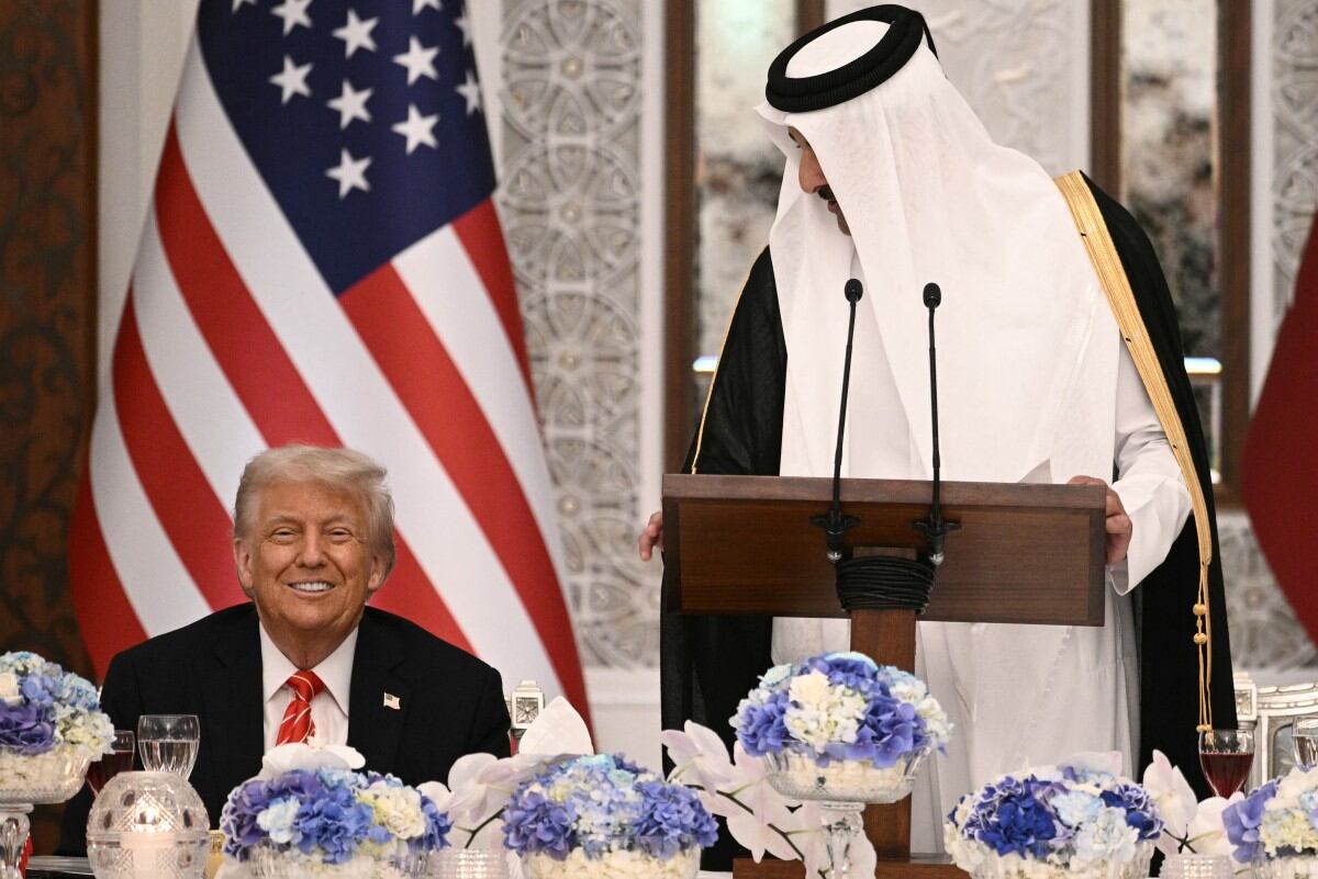 Qatar's Emir Sheikh Tamim bin Hamad al-Thani (R) and US President Donald Trump sit side by side at the Royal Palace in Doha on May 14, 2025. Trump touched down at Hamad International Airport in Doha, with relations between the two governments in the spotlight over Qatar's offer to Trump of a $400 million luxury aircraft to serve as a new Air Force One and then pass into his personal use. (Photo by Brendan SMIALOWSKI / AFP)