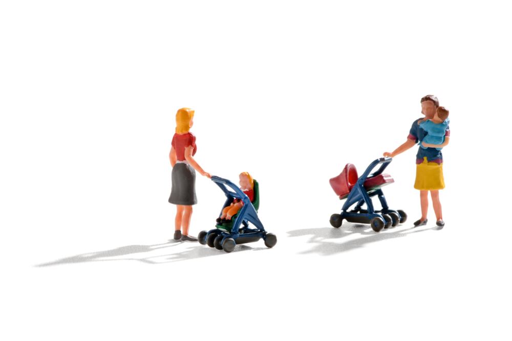 Dos muñecas con coches de bebés.