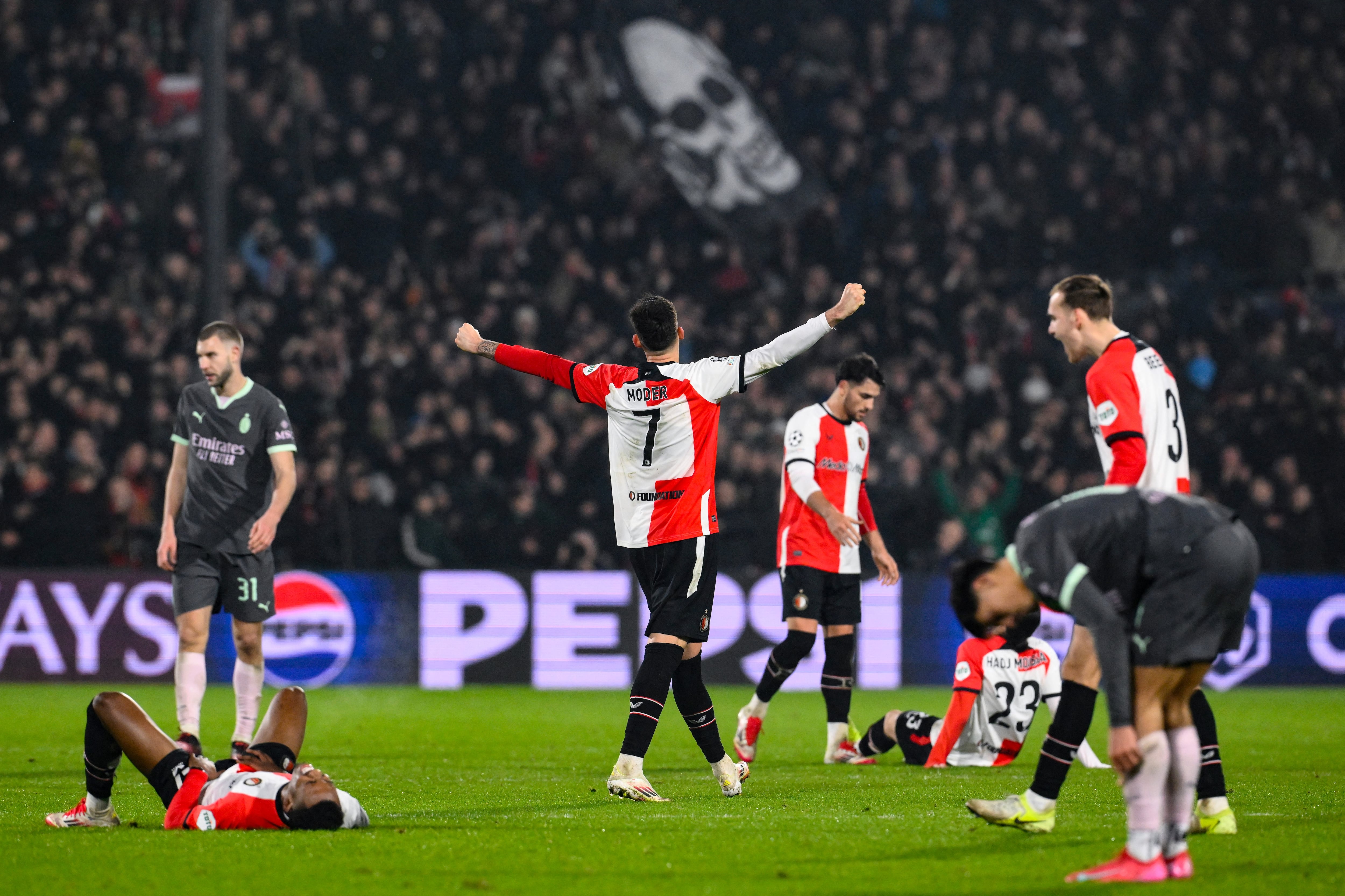 Feyenoord's Polish midfielder #07 Jakub Moder (C) reacts as he celebrates winning the UEFA Champions League knockout phase play-off 1st leg football match between Feyenoord Rotterdam and AC Milan at the Stadion Feijenoord "De Kuip" in Rotterdam, on February 12, 2025. (Photo by JOHN THYS / AFP)