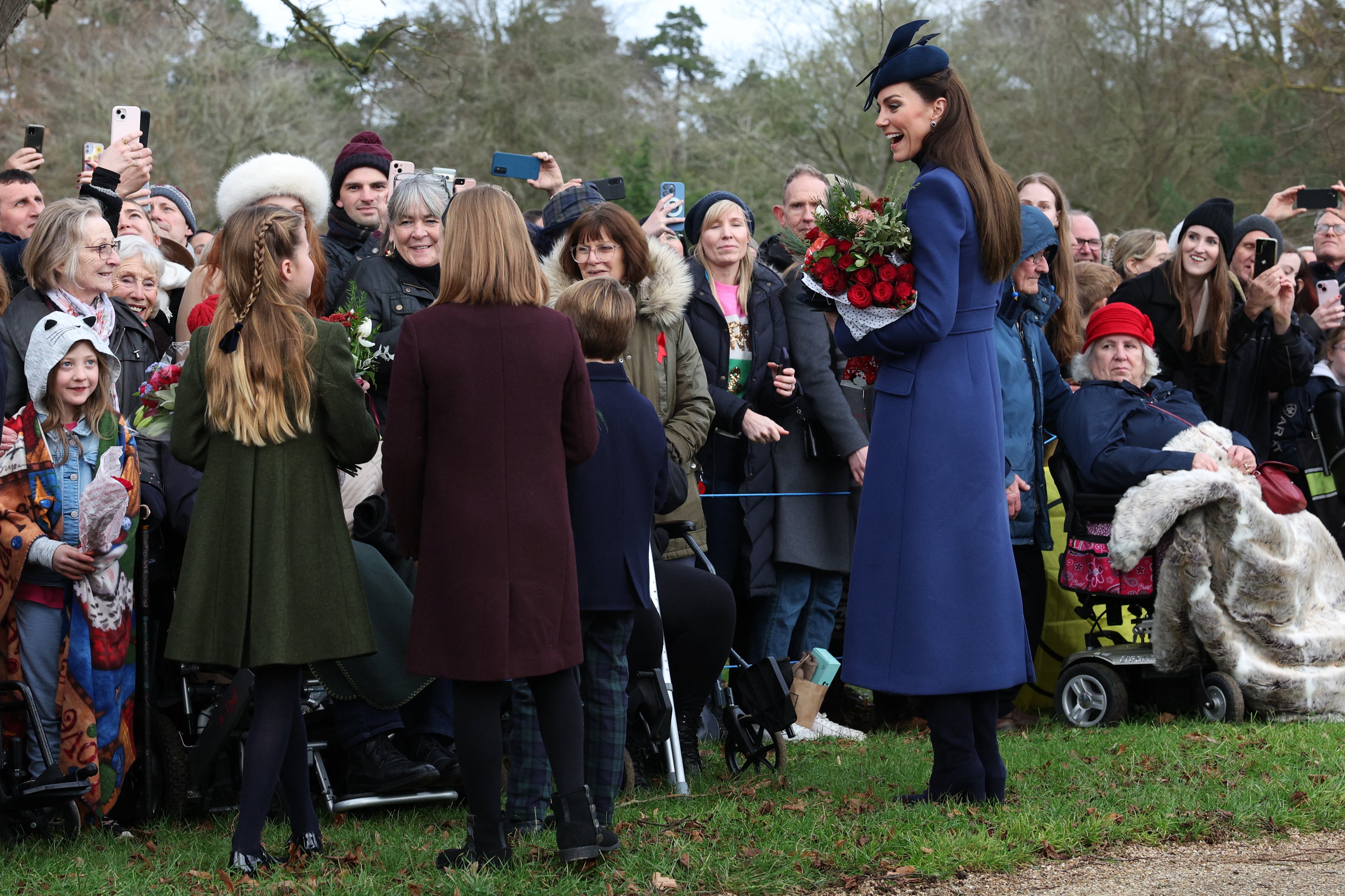 Britain's Catherine, Princess of Wales (R), Britain's Prince Louis of Wales (2R), Mia Tindall (2L) and Britain's Princess Charlotte of Wales (L) chat with well-wishers after attending the Royal Family's traditional Christmas Day service at St Mary Magdalene Church on the Sandringham Estate in eastern England, on December 25, 2023. (Photo by Adrian DENNIS / AFP)